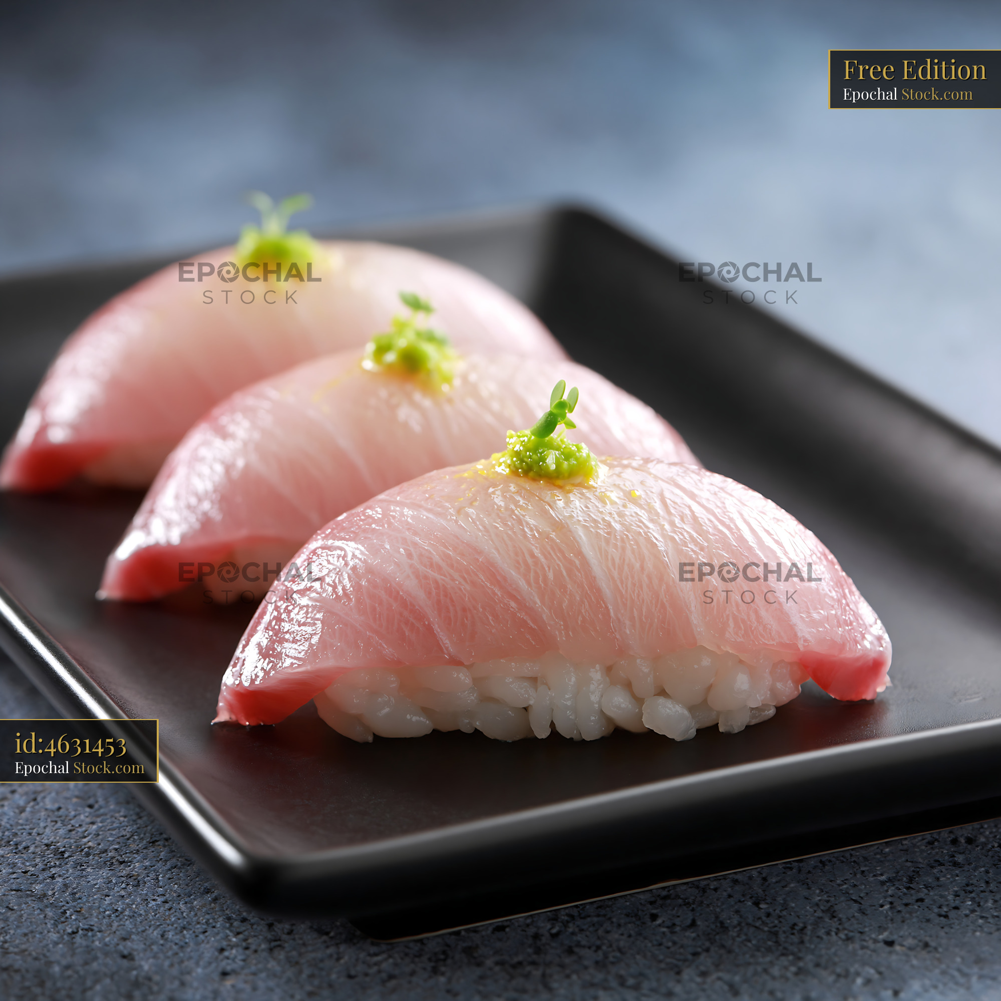 Fresh yellowtail nigiri sushi with yuzu kosho on a black plate - stock photo