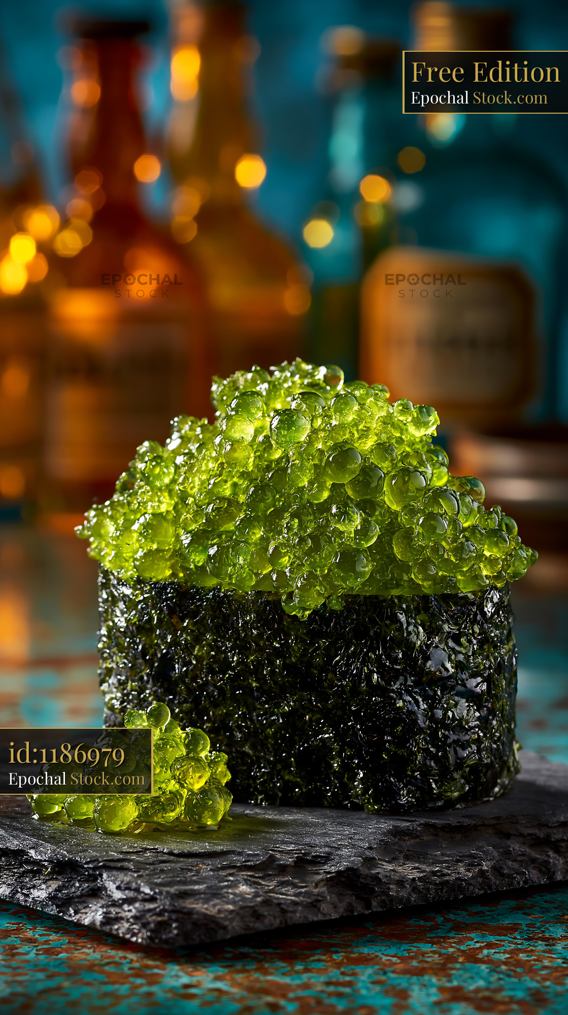 Umi budo sushi gunkan topped with green sea grapes on slate platter - stock photo
