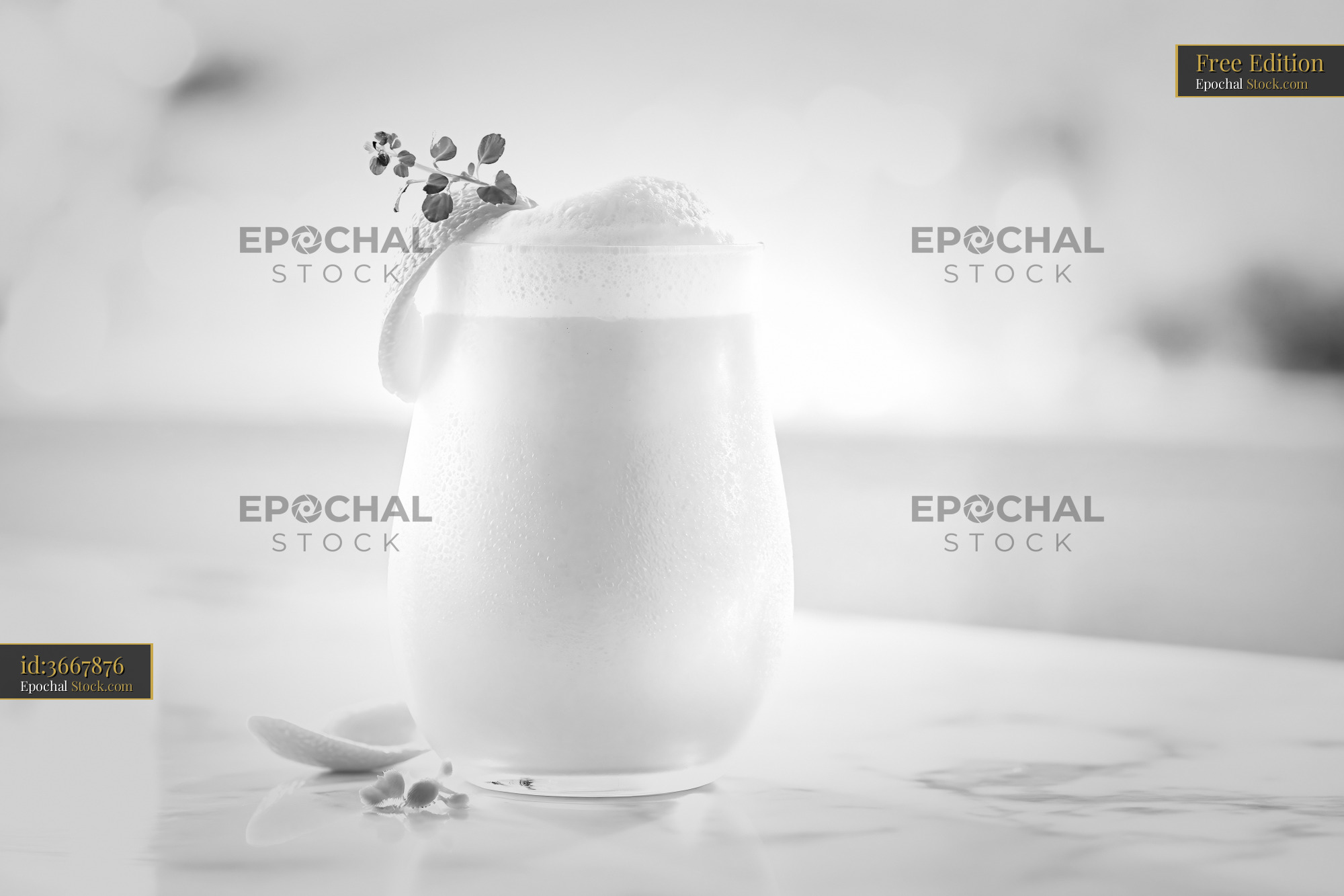 Mikan orange smoothie with frothy foam and citrus garnish on marble - stock photo