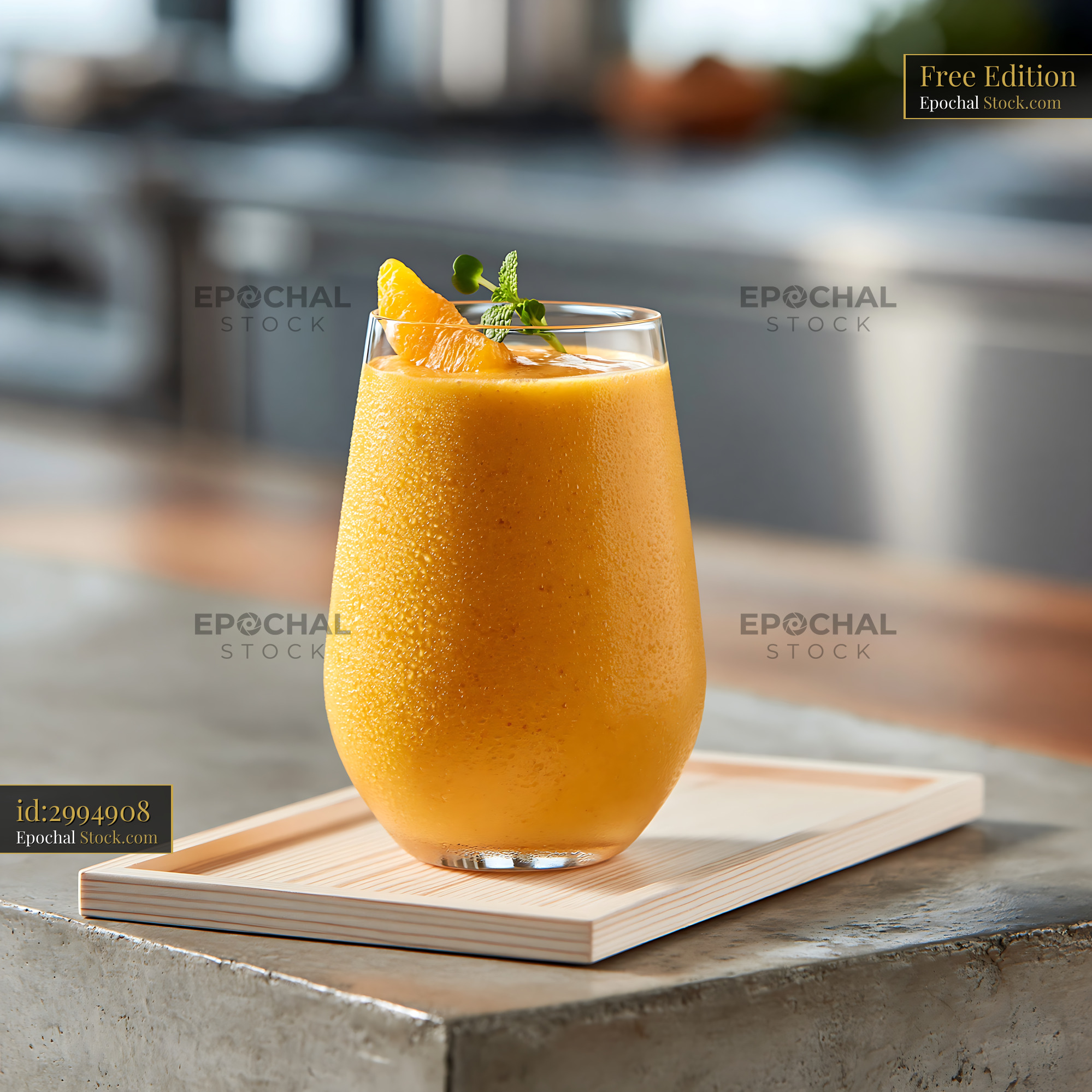 Fresh mikan orange smoothie in a glass garnished with mint - stock photo