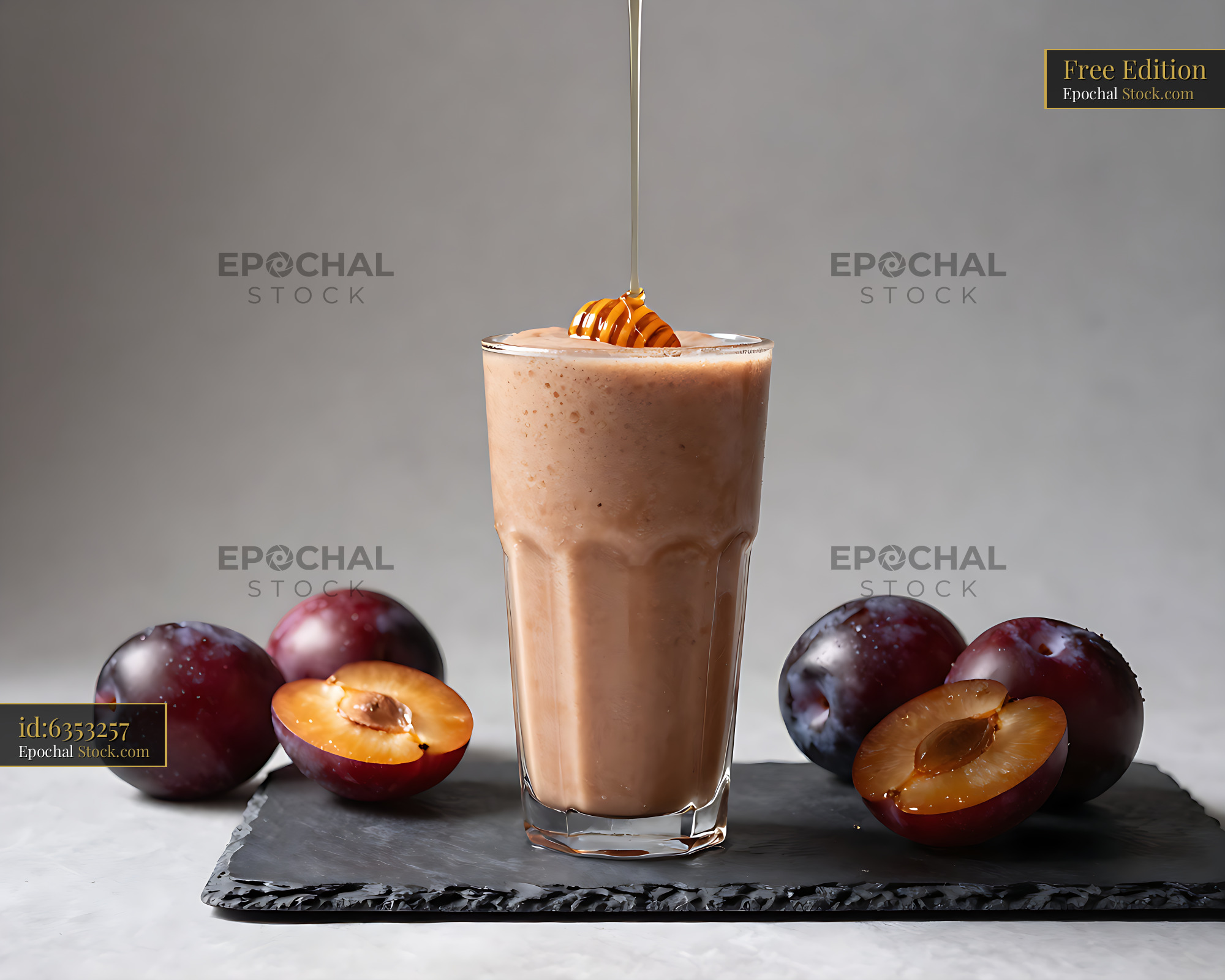 Damson Dewdrop smoothie with fresh plums and honey pouring into glass - stock photo