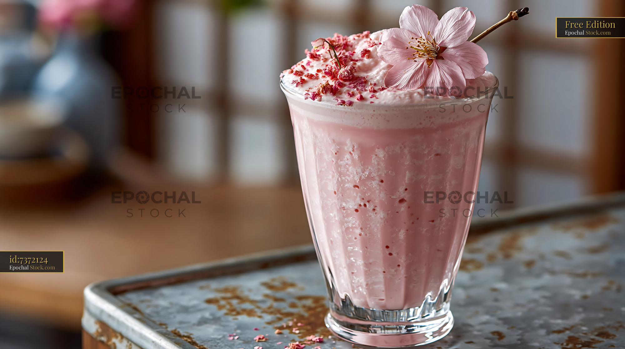 Pink sakura blossom smoothie topped with whipped foam and fresh flower - stock photo