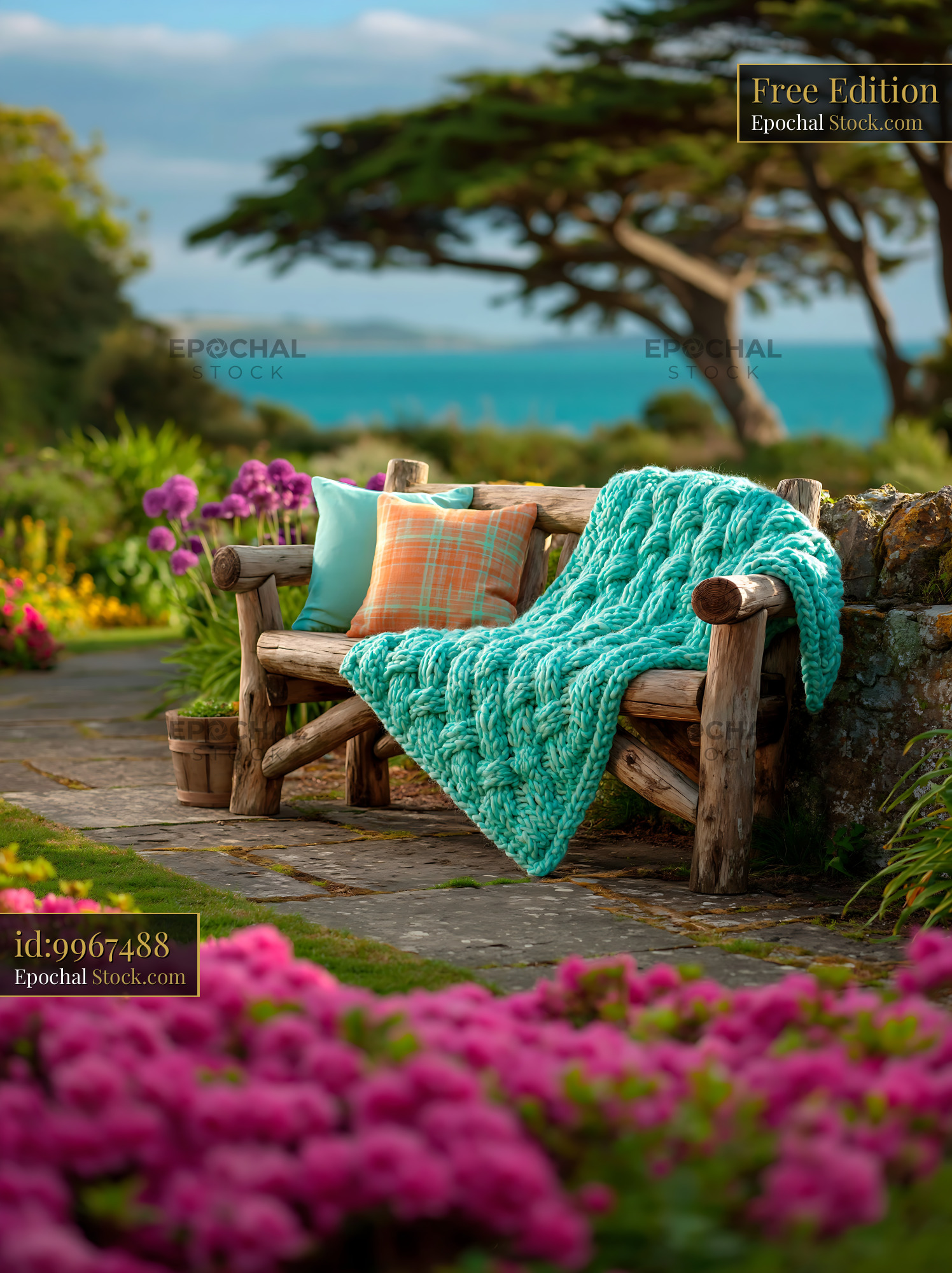 Rustic wooden bench with patterned blanket park seat overlooking sea - stock photo