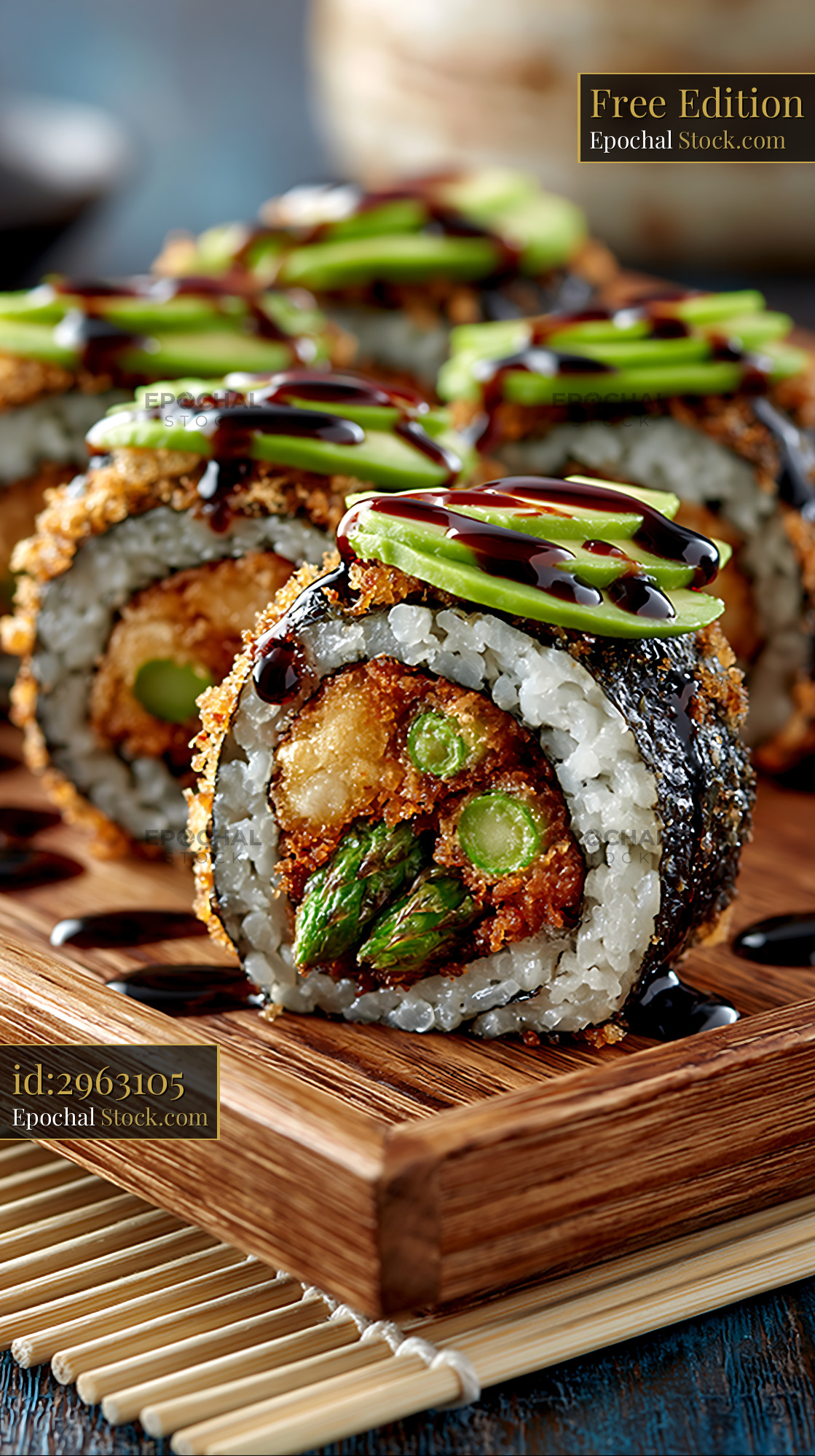 Tempura asparagus sushi rolls topped with avocado and sweet glaze - stock photo