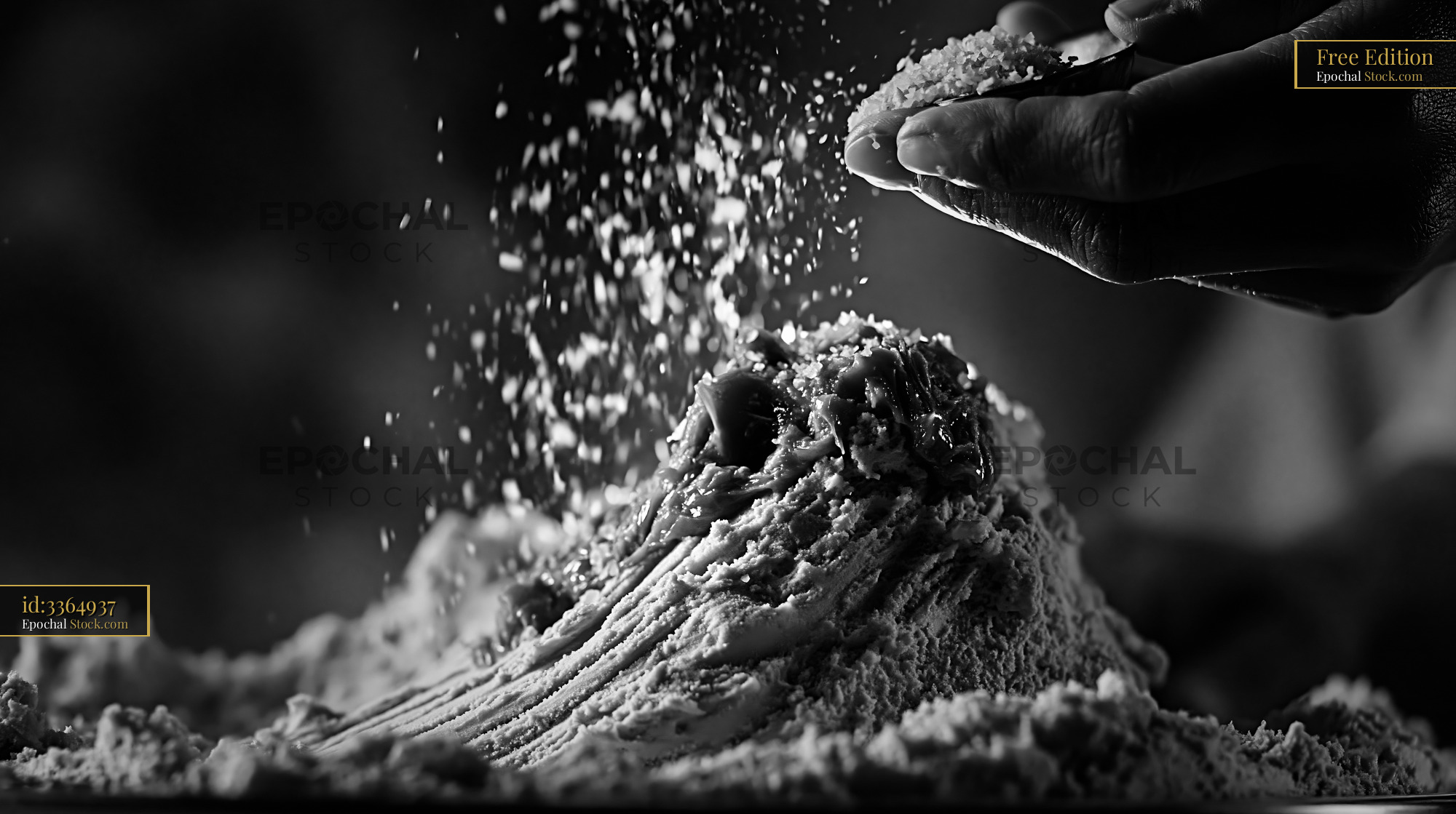 Hand sprinkling fleur de sel onto gourmet caramel ice cream - stock photo