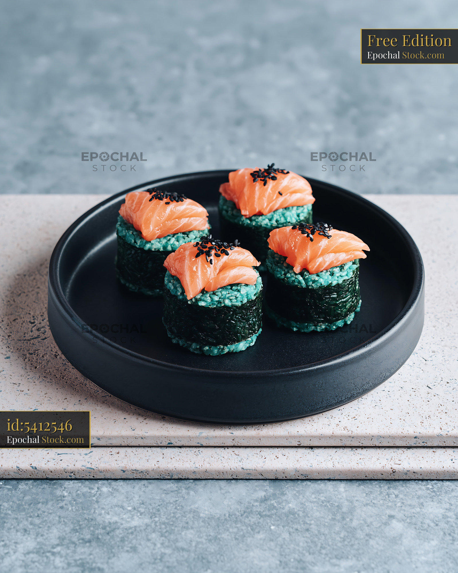 Salmon sushi rolls with blue spirulina rice and black sesame seeds - stock photo