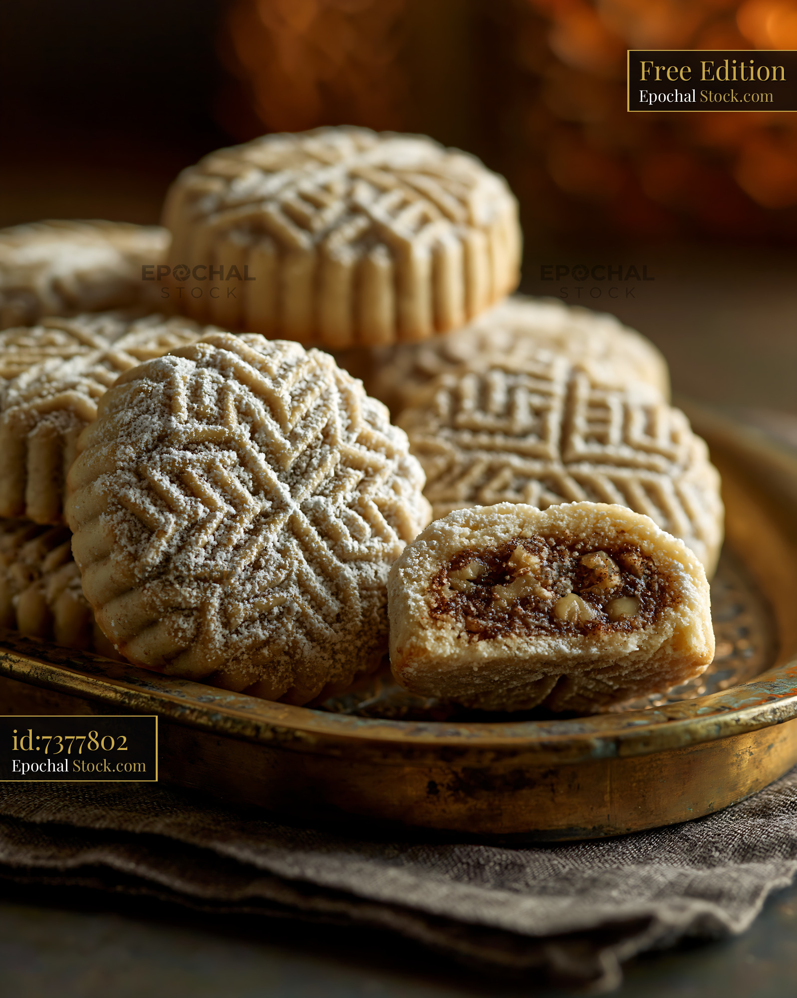 Traditional walnut maamoul biscuits on a golden tray with warm lightin - stock photo