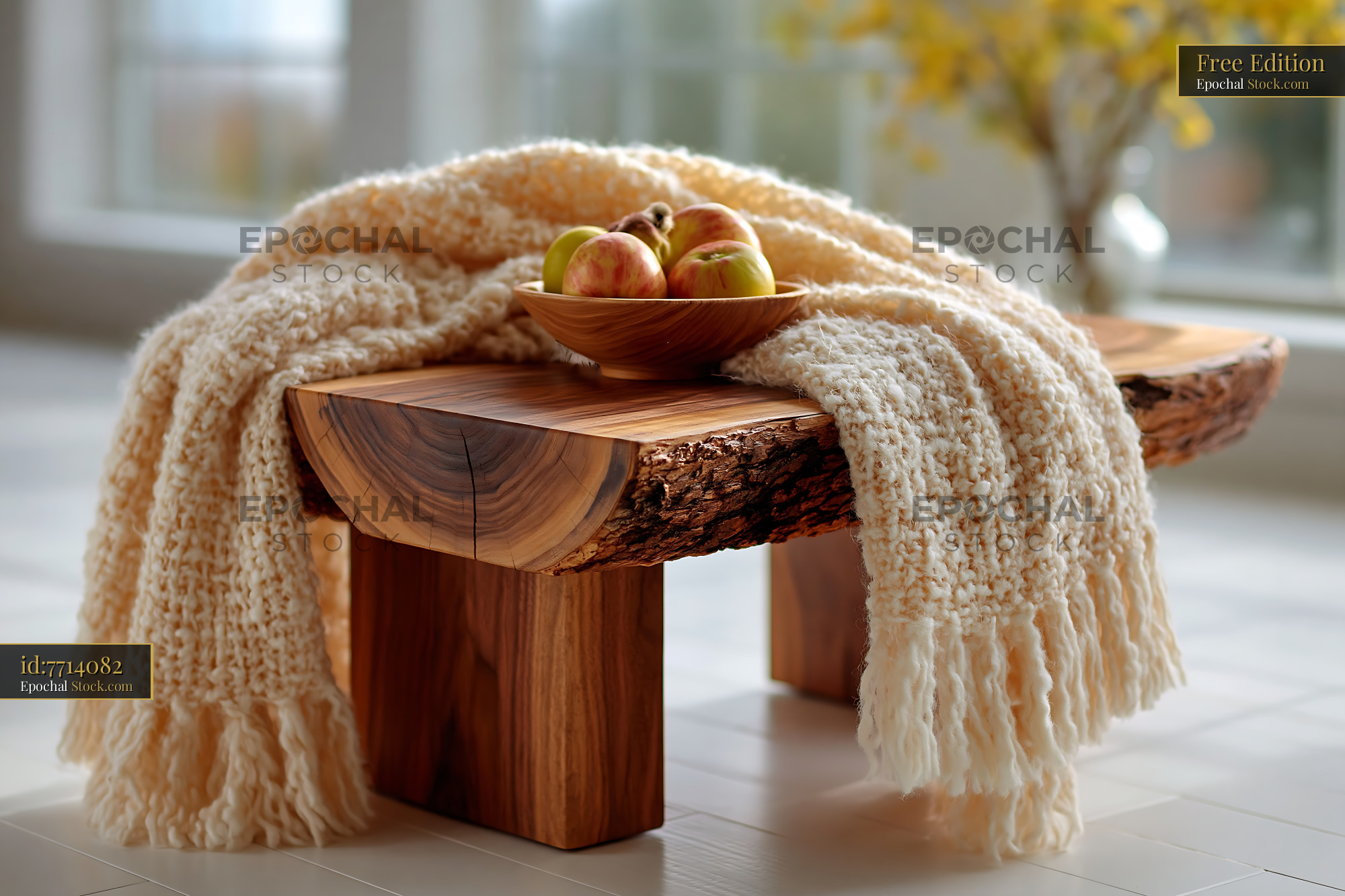 Rustic wooden bench with cream knit throw and bowl of fresh apples - stock photo