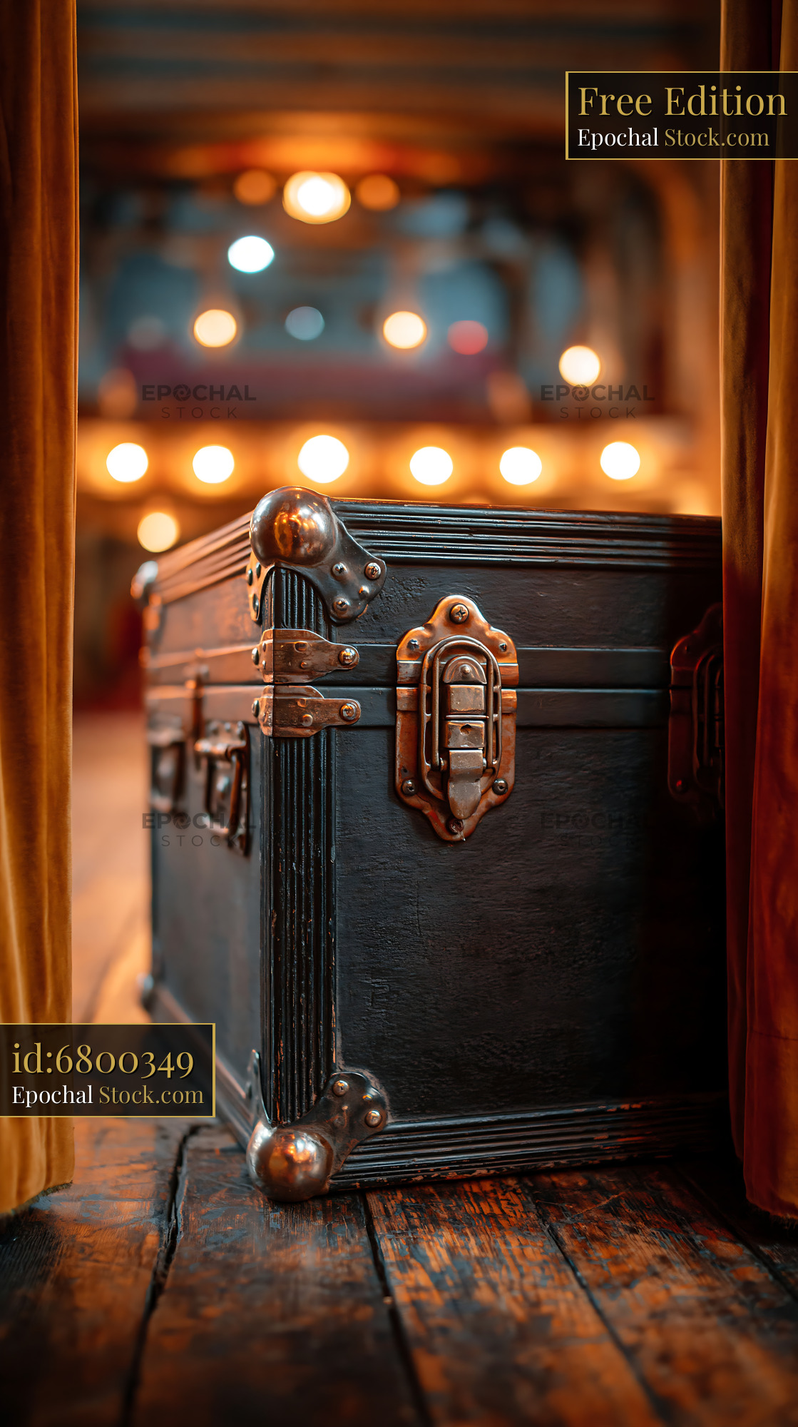 Vintage flight case on a wooden theater stage with warm bokeh lights
