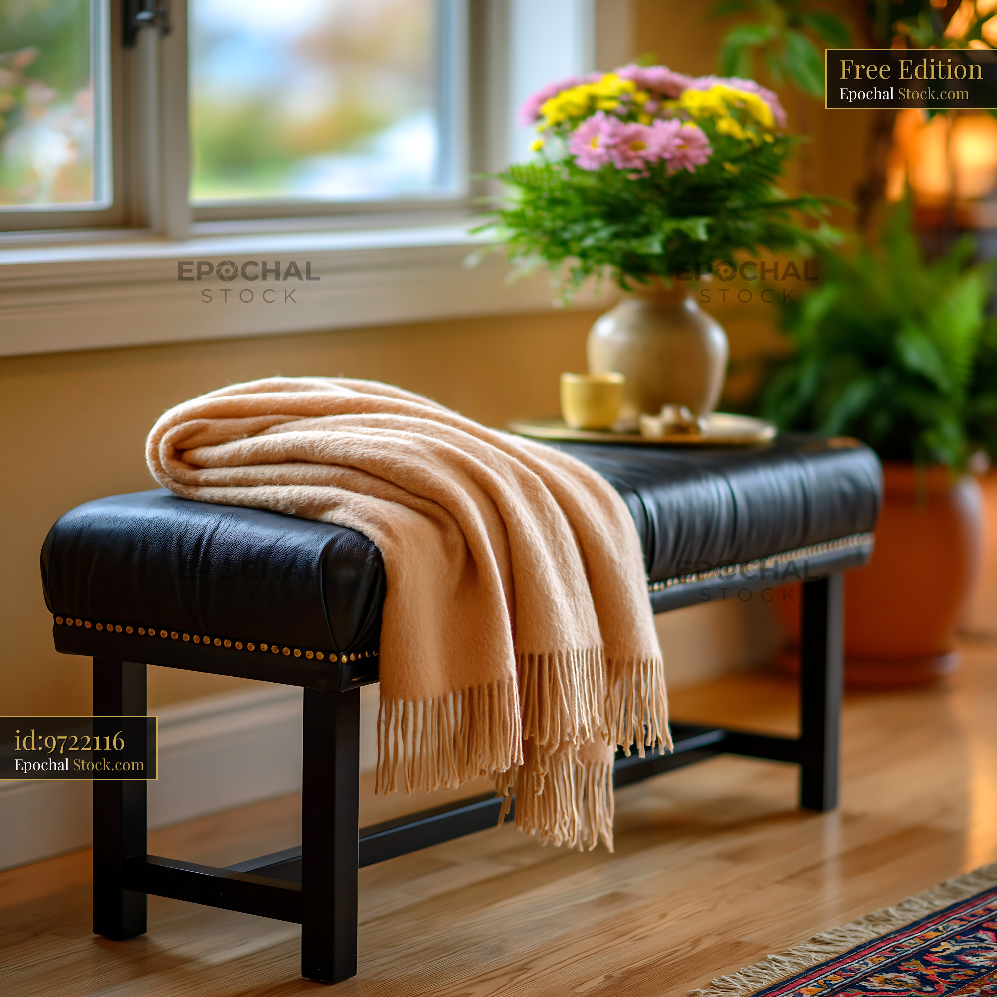 Beige cashmere throw on black leather bench in cozy living room - stock photo