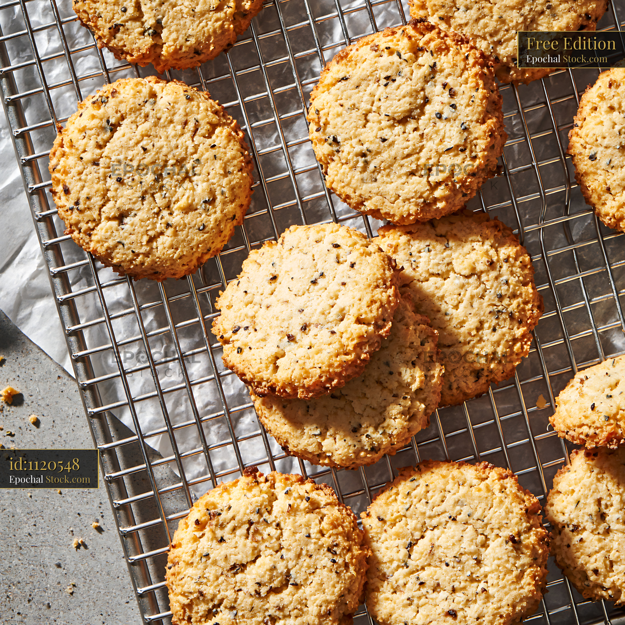 Freshly baked cardamom chickpea biscuits on a cooling rack - stock photo