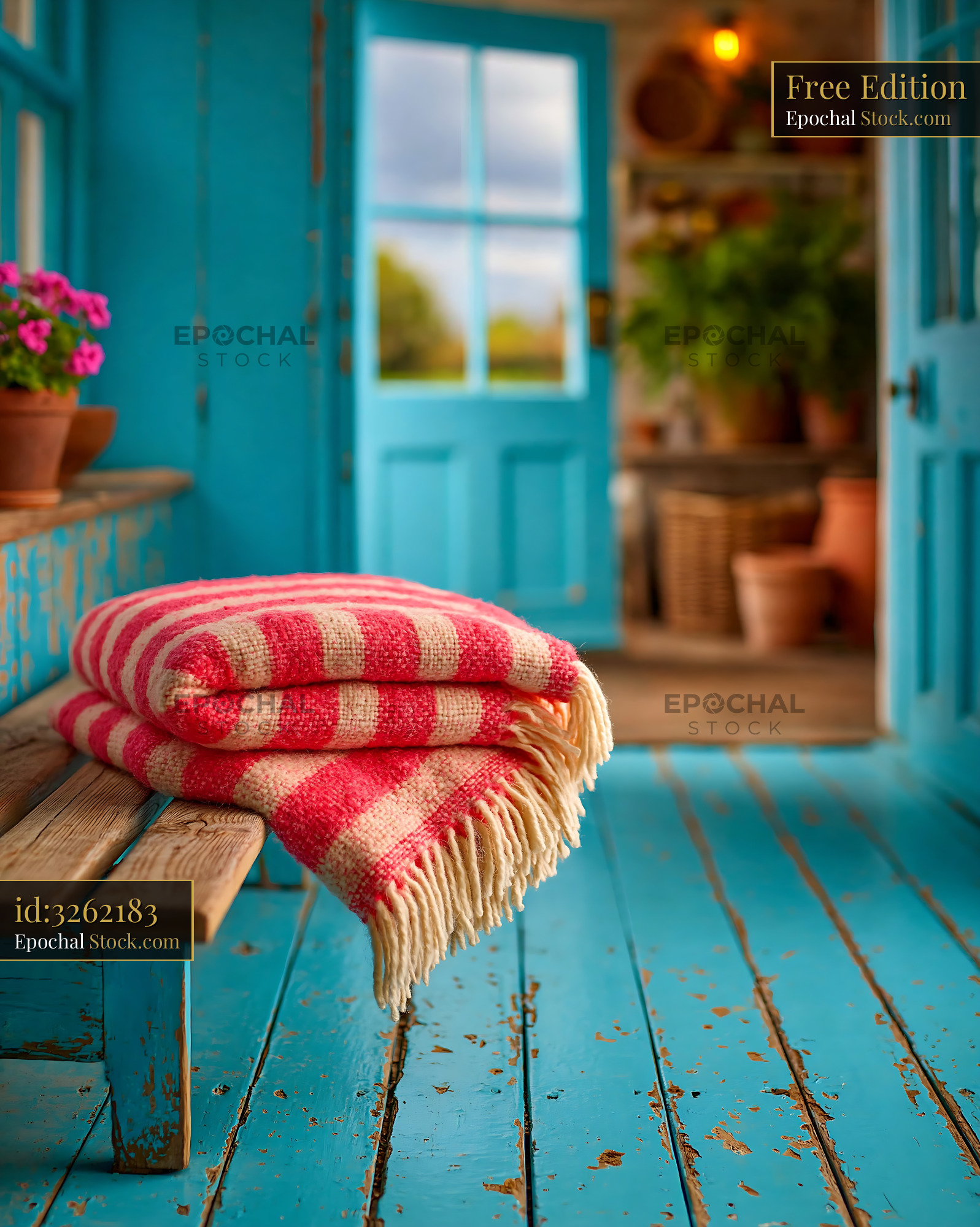 Folded pink striped wool blanket on a blue shabby chic wooden bench - stock photo