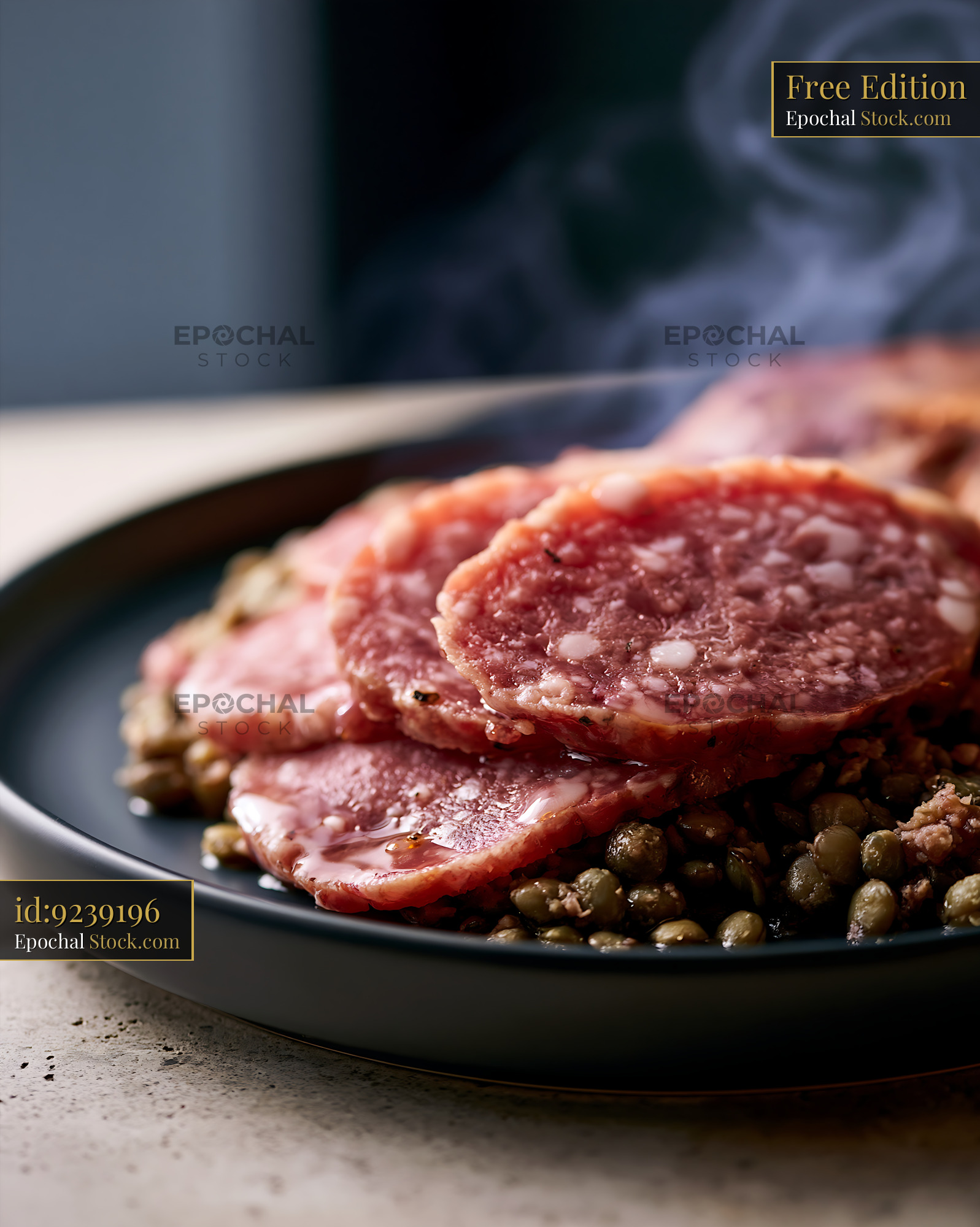 Steaming slices of cotechino modena meat served with green lentils - stock photo