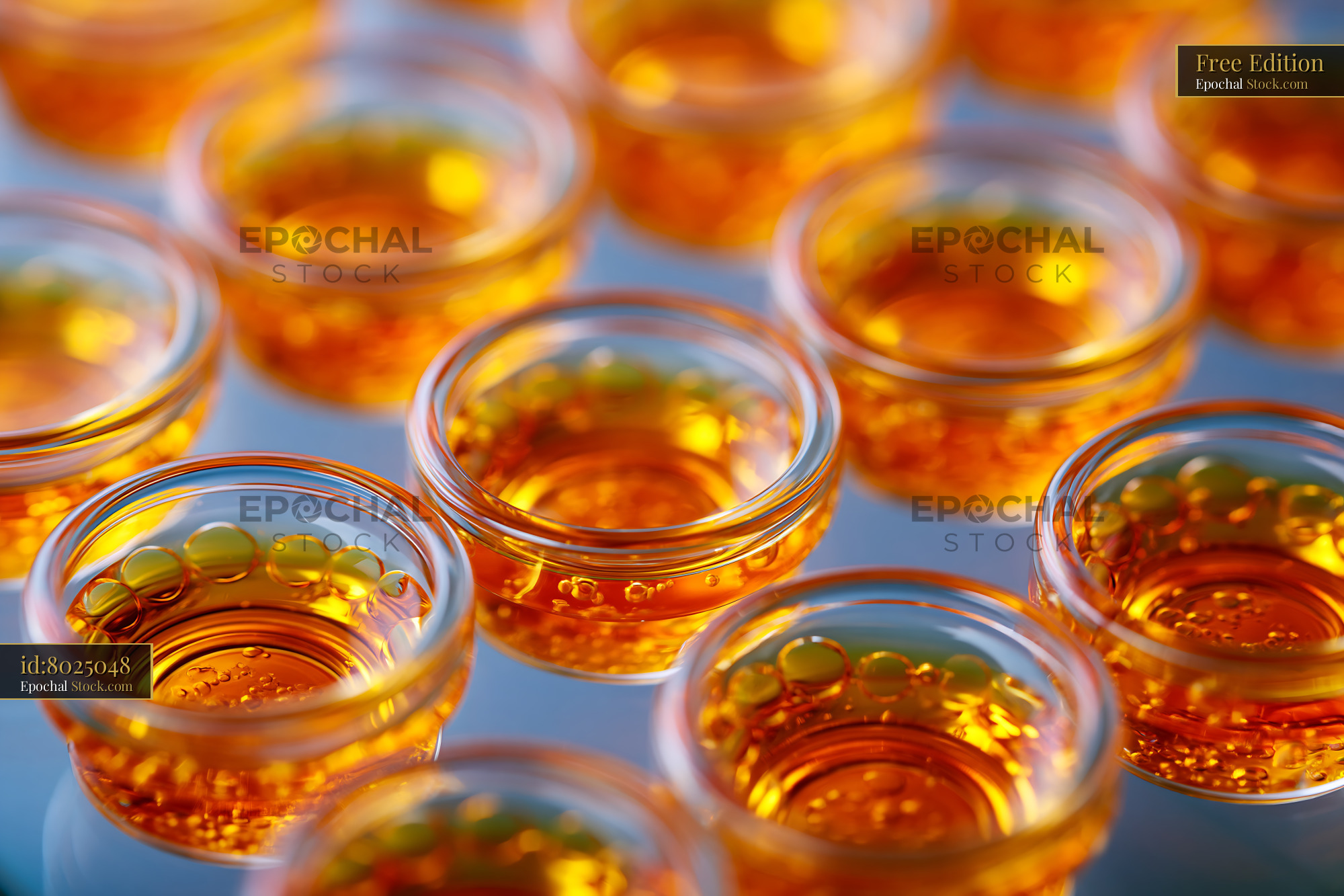 Laboratory wells with golden liquid for molecular interaction study - stock photo