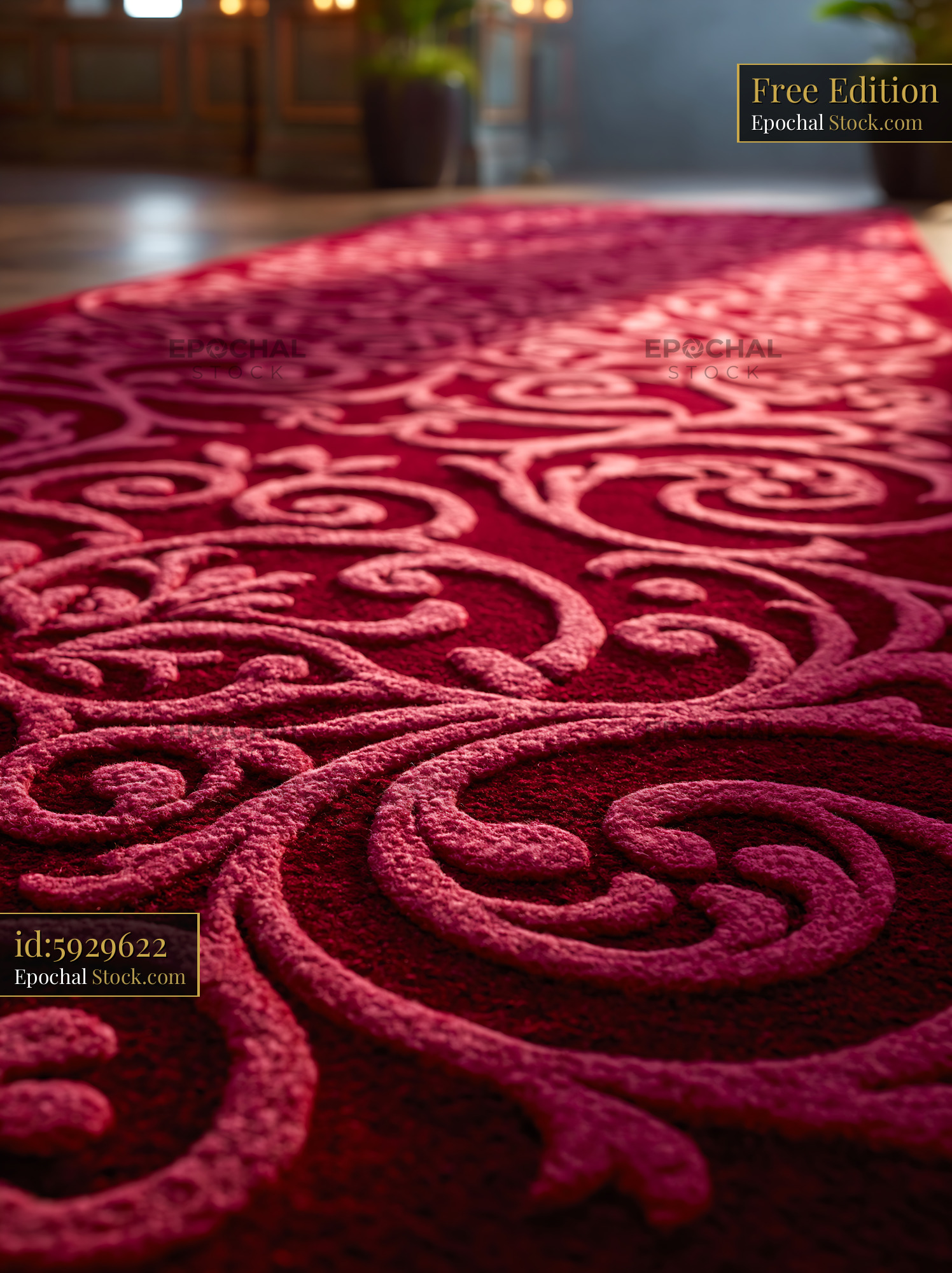 Luxury hotel lobby red carpet with ornate patterns in soft light - stock photo