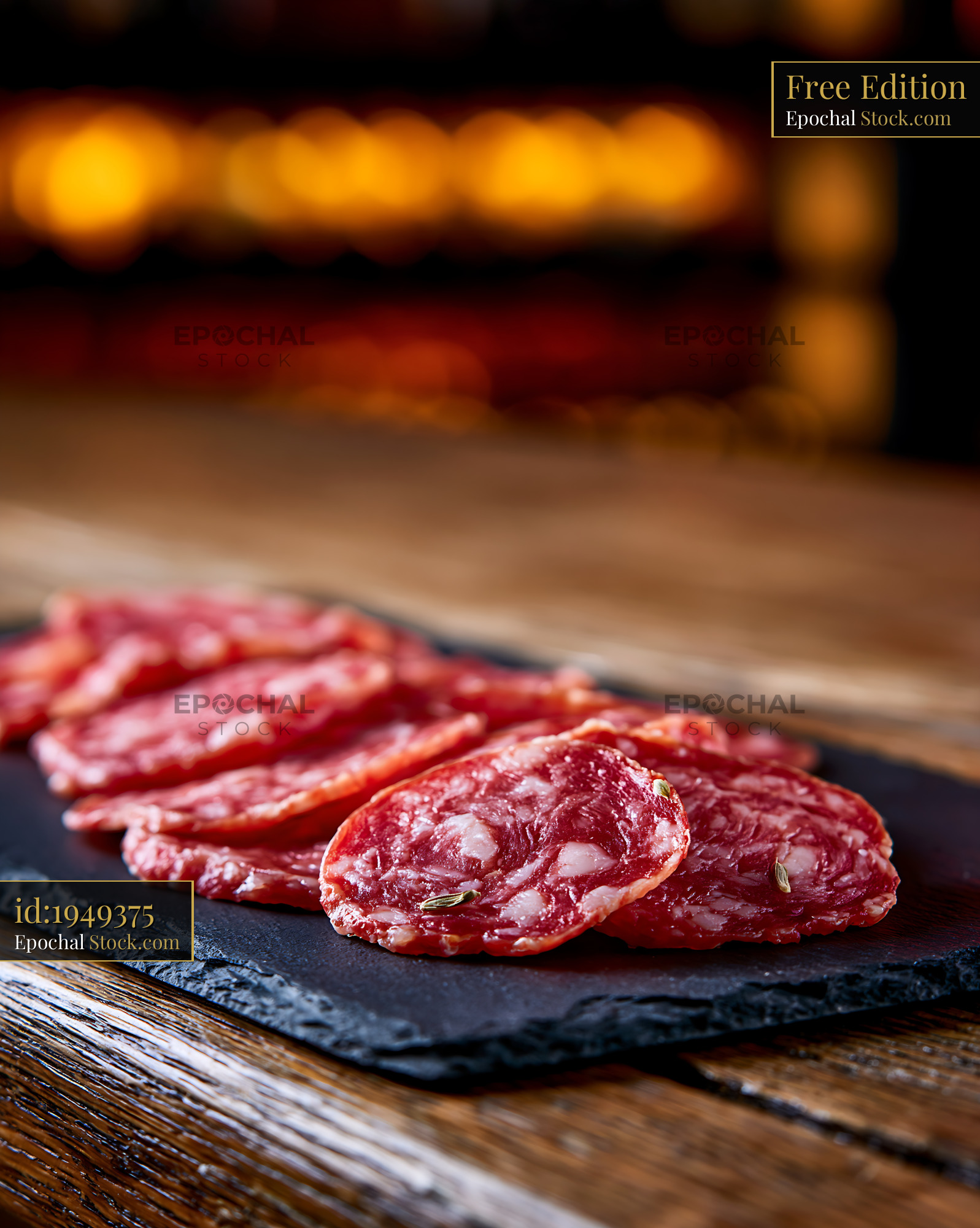 Slices of authentic Finocchiona IGP meat on a rustic slate board - stock photo