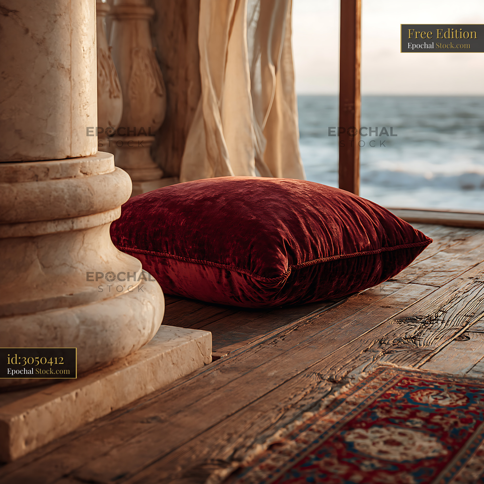 Red velvet cushion on a luxury hotel balcony view overlooking the sea - stock photo