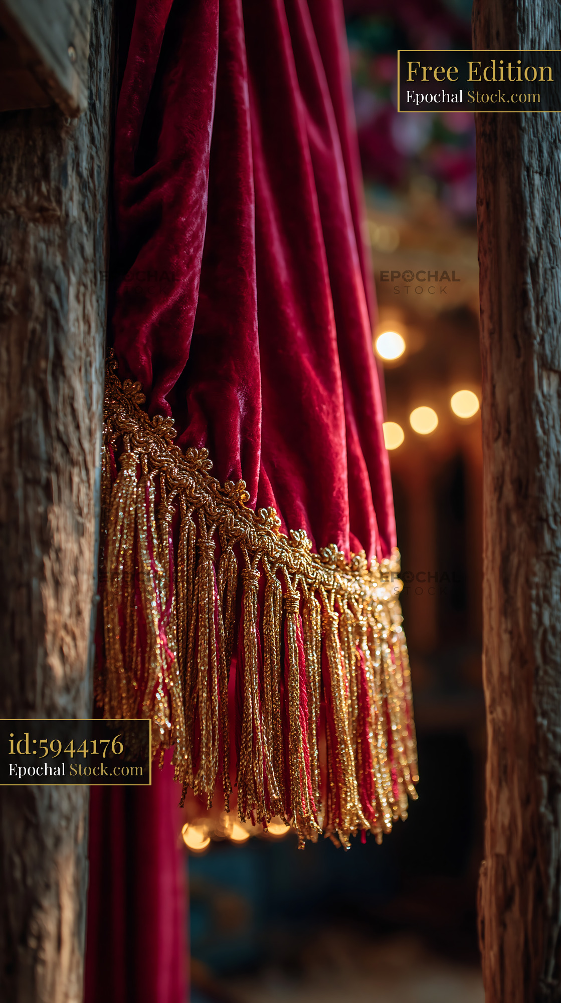 Red velvet stage curtain with gold fringe between wooden beams - stock photo
