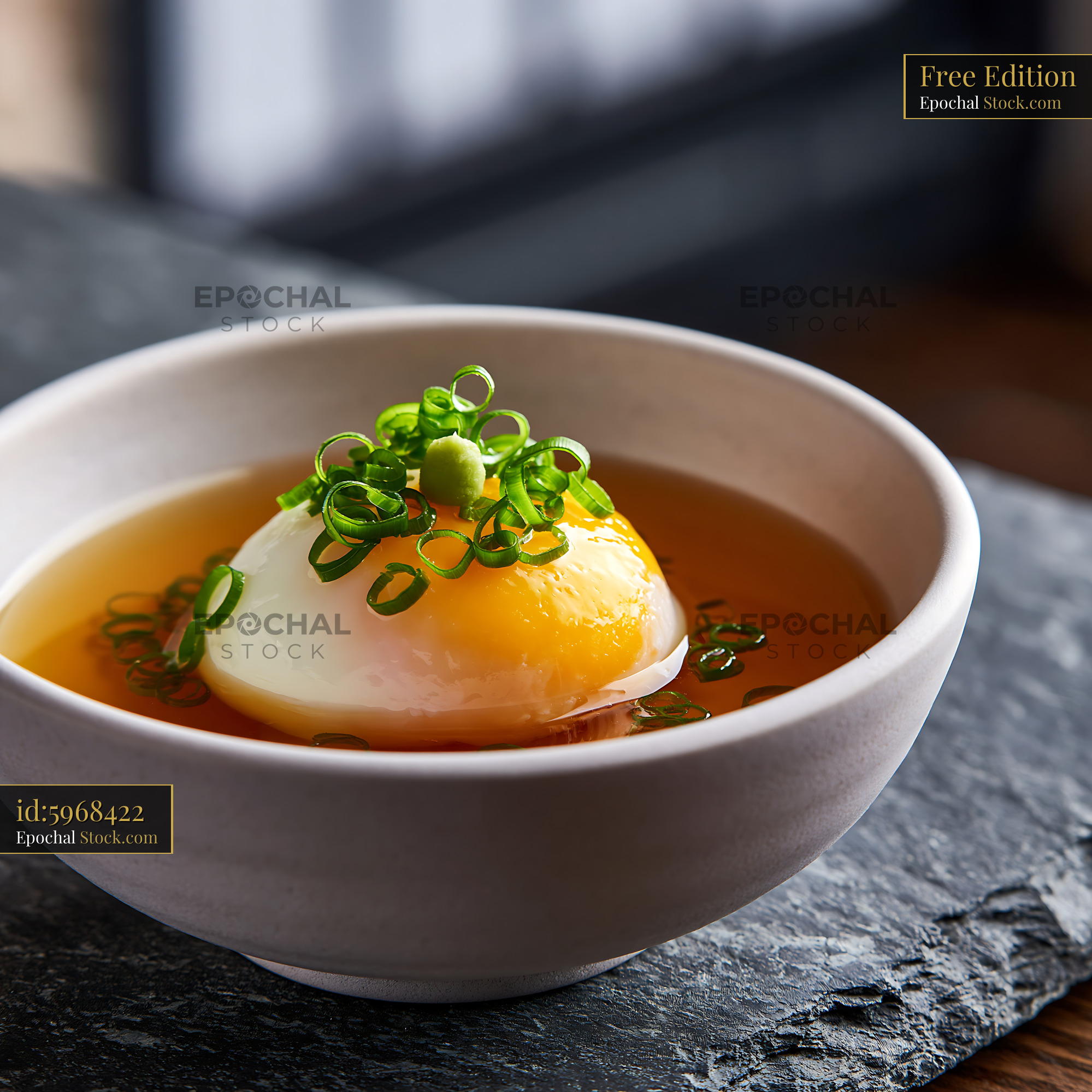 Japanese onsen tamago egg served in savory dashi broth - stock photo
