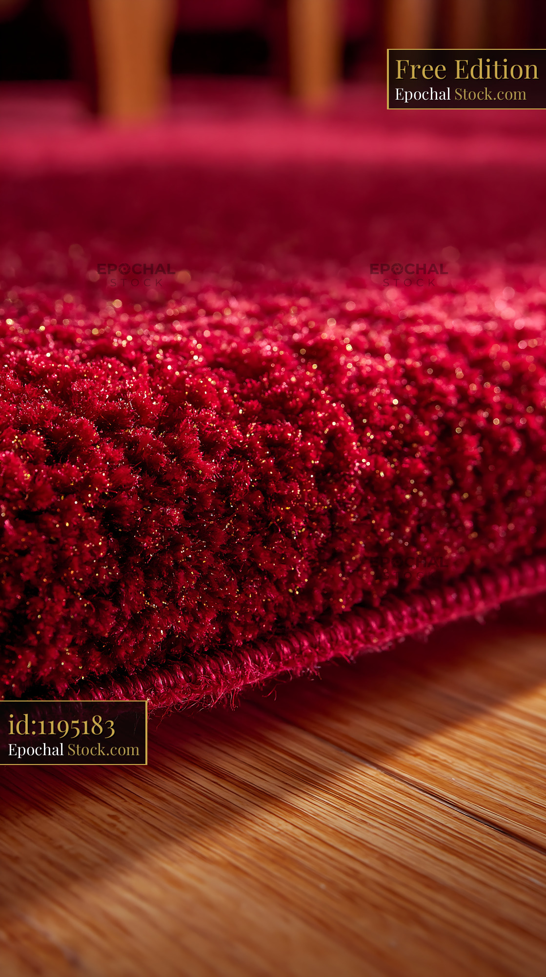 Close up of a thick red carpet on a wooden floor in an empty theater - stock photo