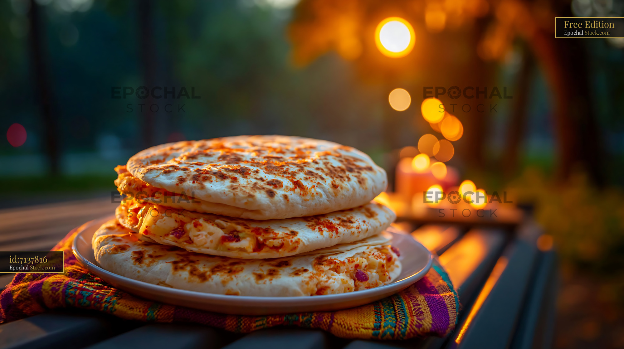Stack of toasted wraps on a park bench during golden hour - stock photo