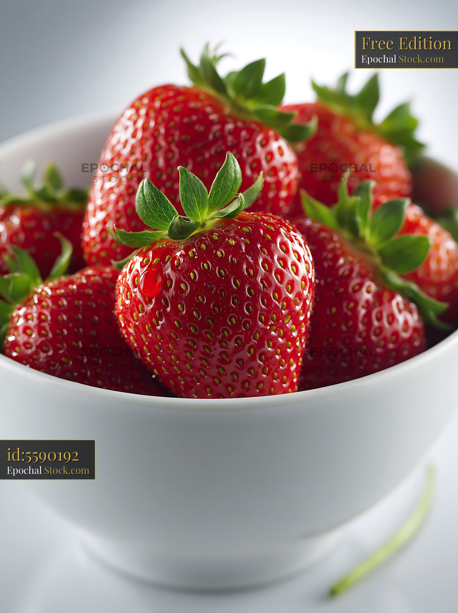 Fresh strawberries in a white ceramic bowl on a bright background - stock photo