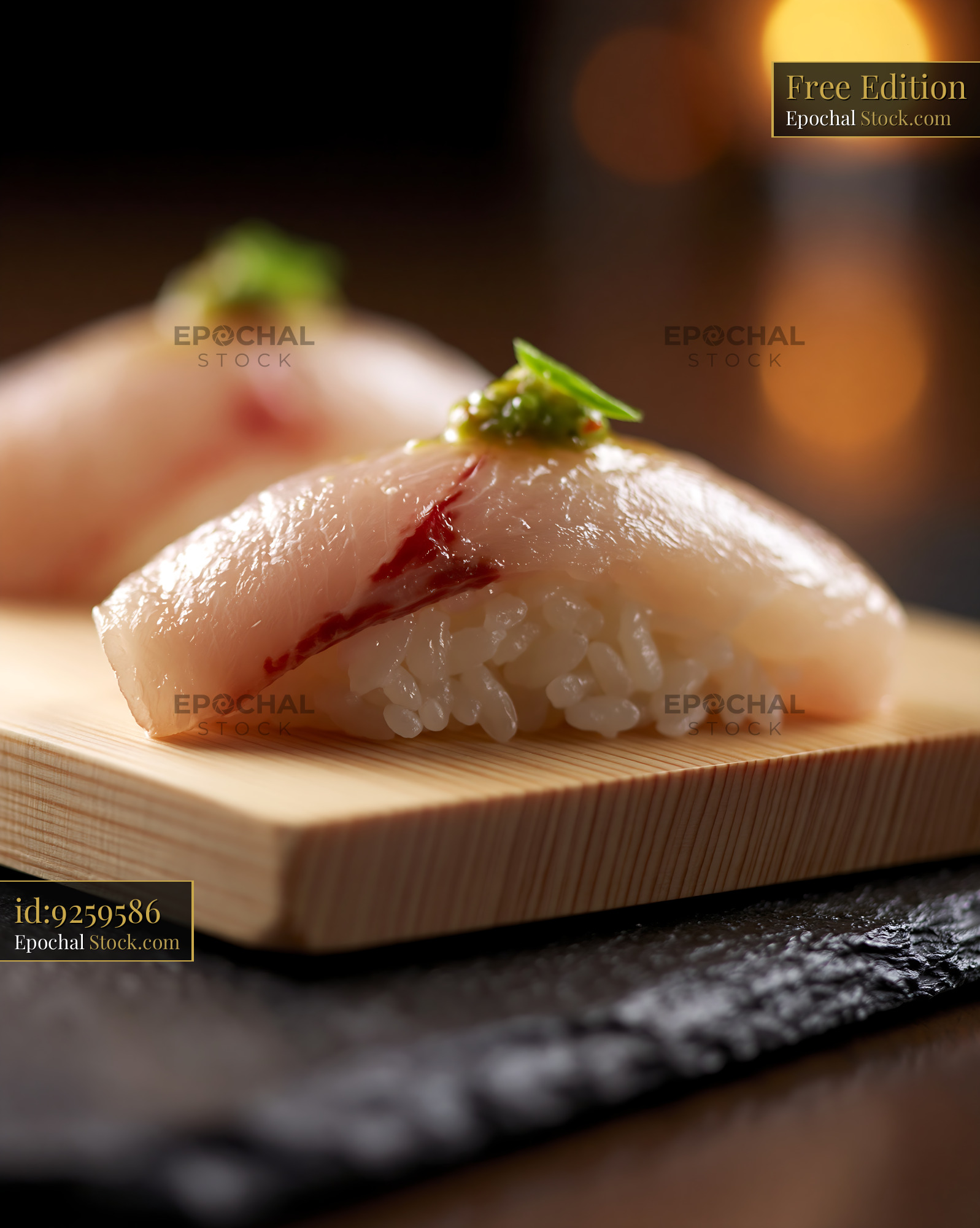 Fresh yellowtail nigiri with yuzu kosho on a traditional wooden block - stock photo
