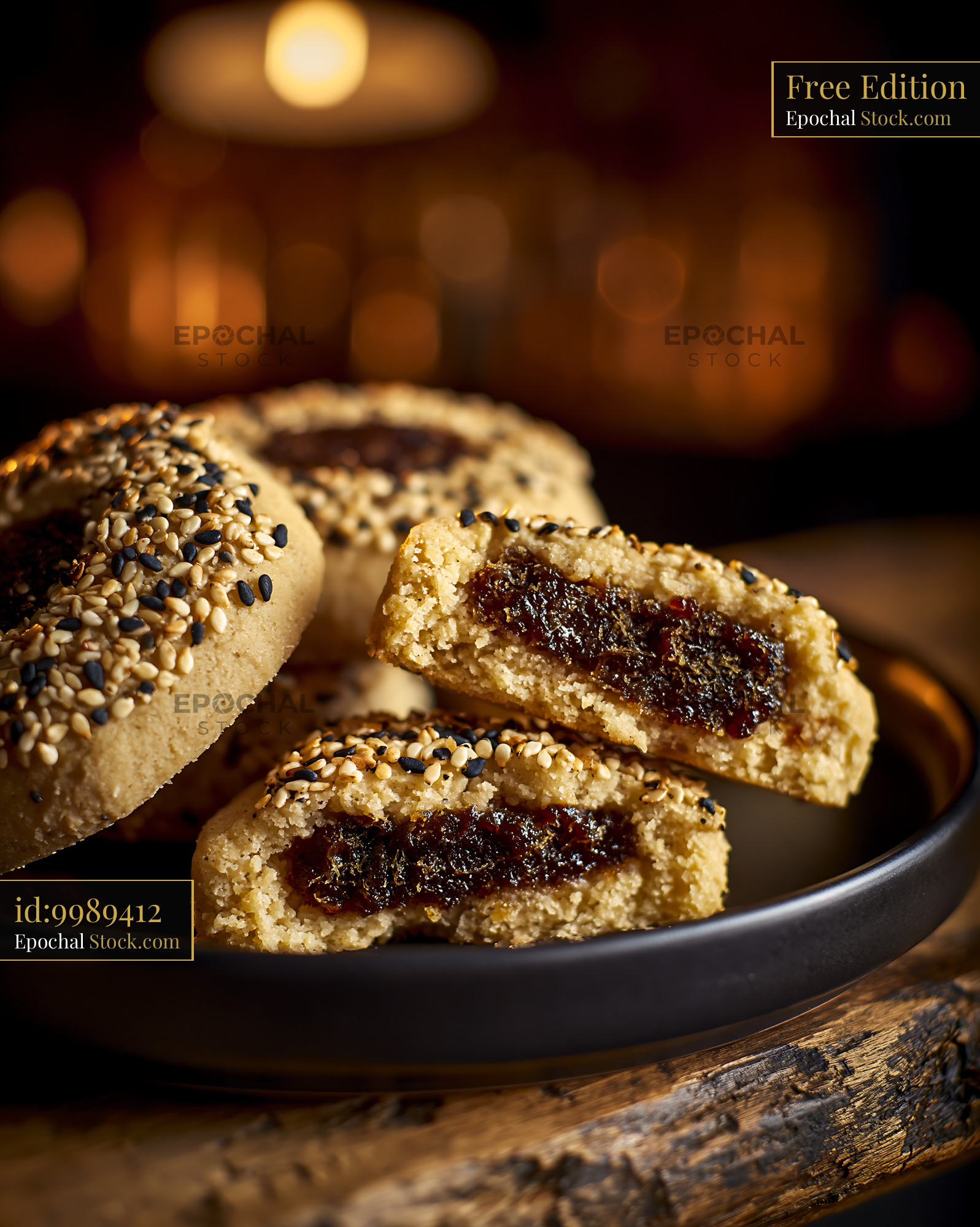 Tahini date biscuits with sesame seeds on a plate in warm light - stock photo
