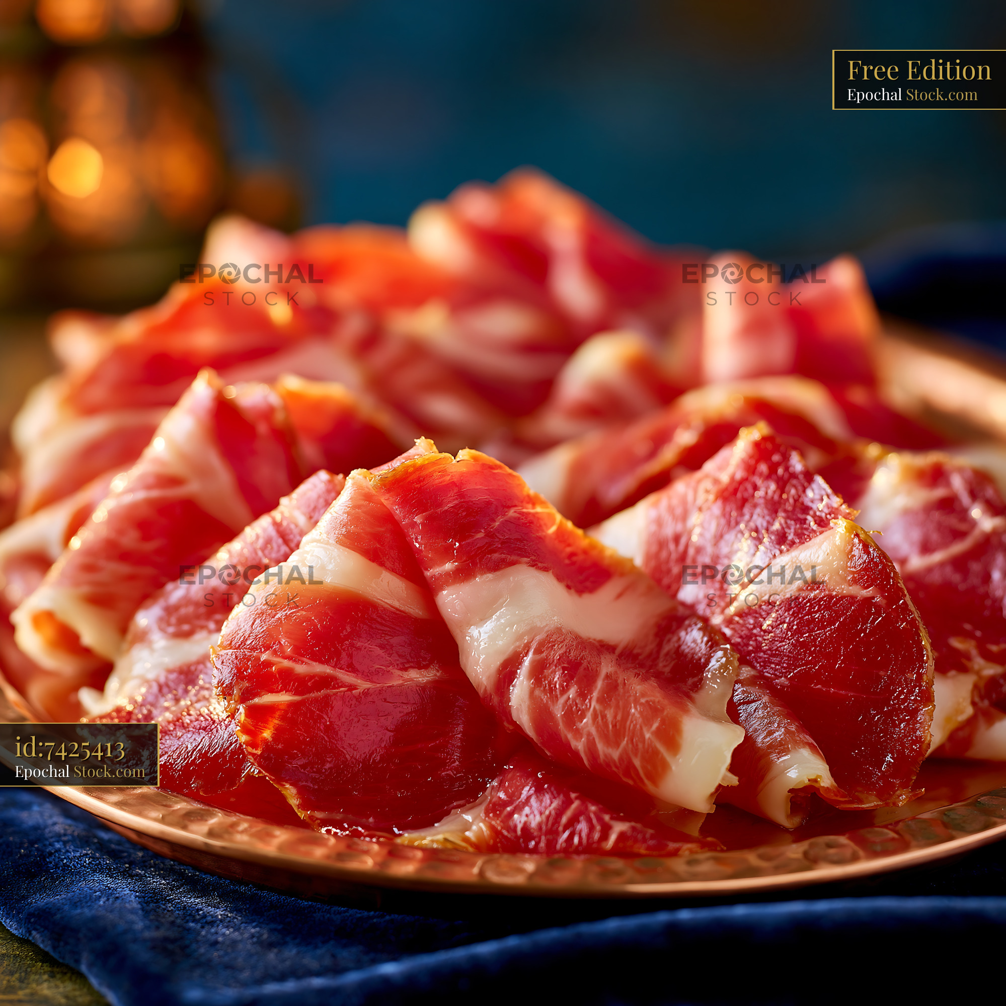 Thin slices of Jambon de Bayonne meat on a copper platter - stock photo