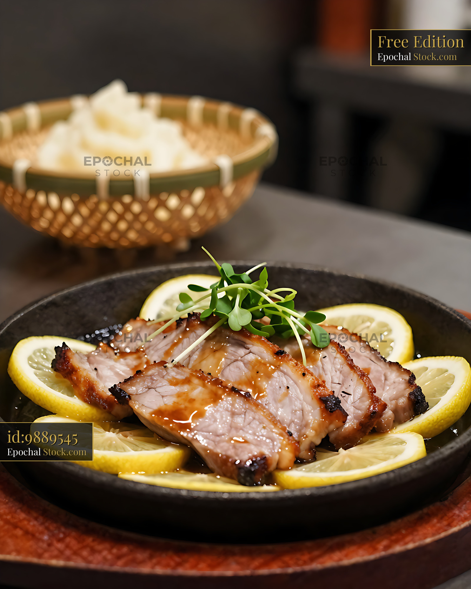 Slices of Tochigi lemon steak buta served in a cast iron skillet - stock photo