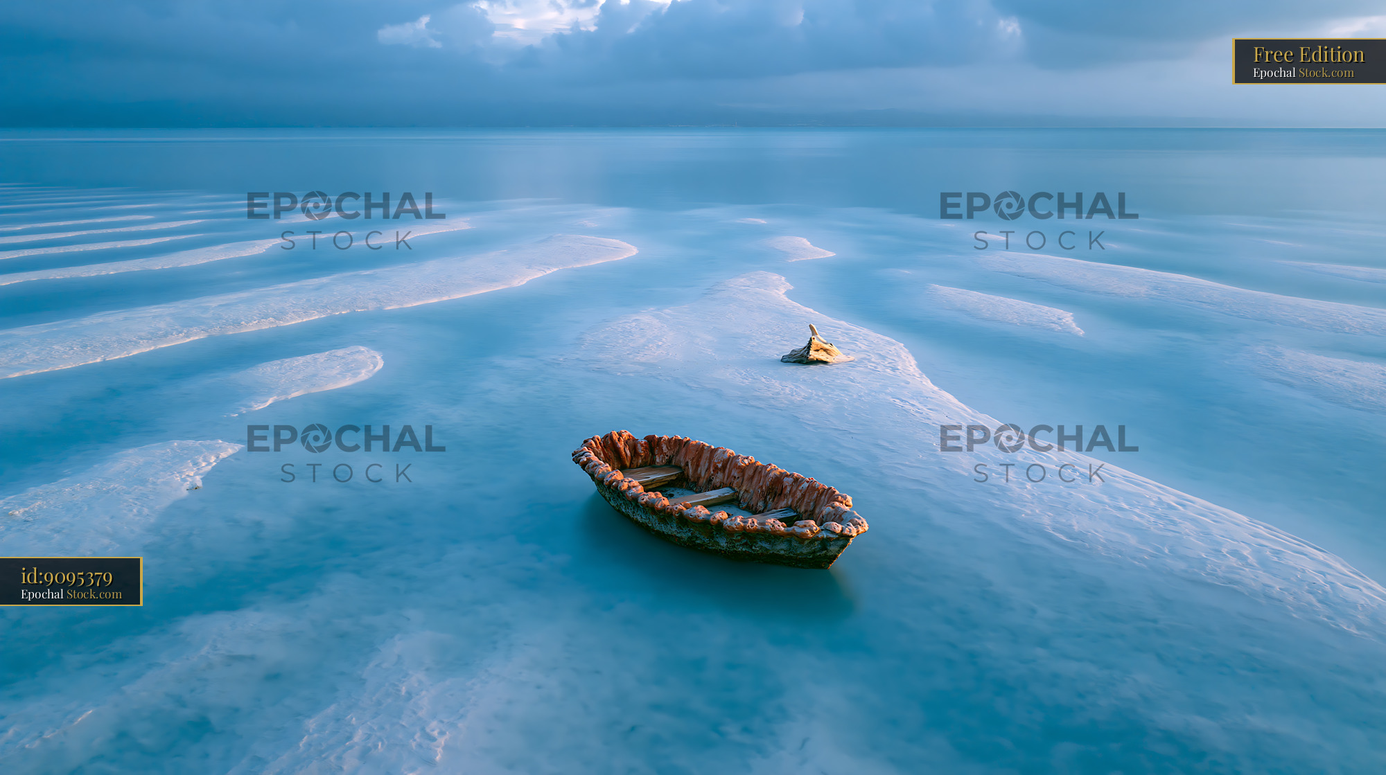 Weathered wooden boat on a white sandbar in turquoise water - stock photo