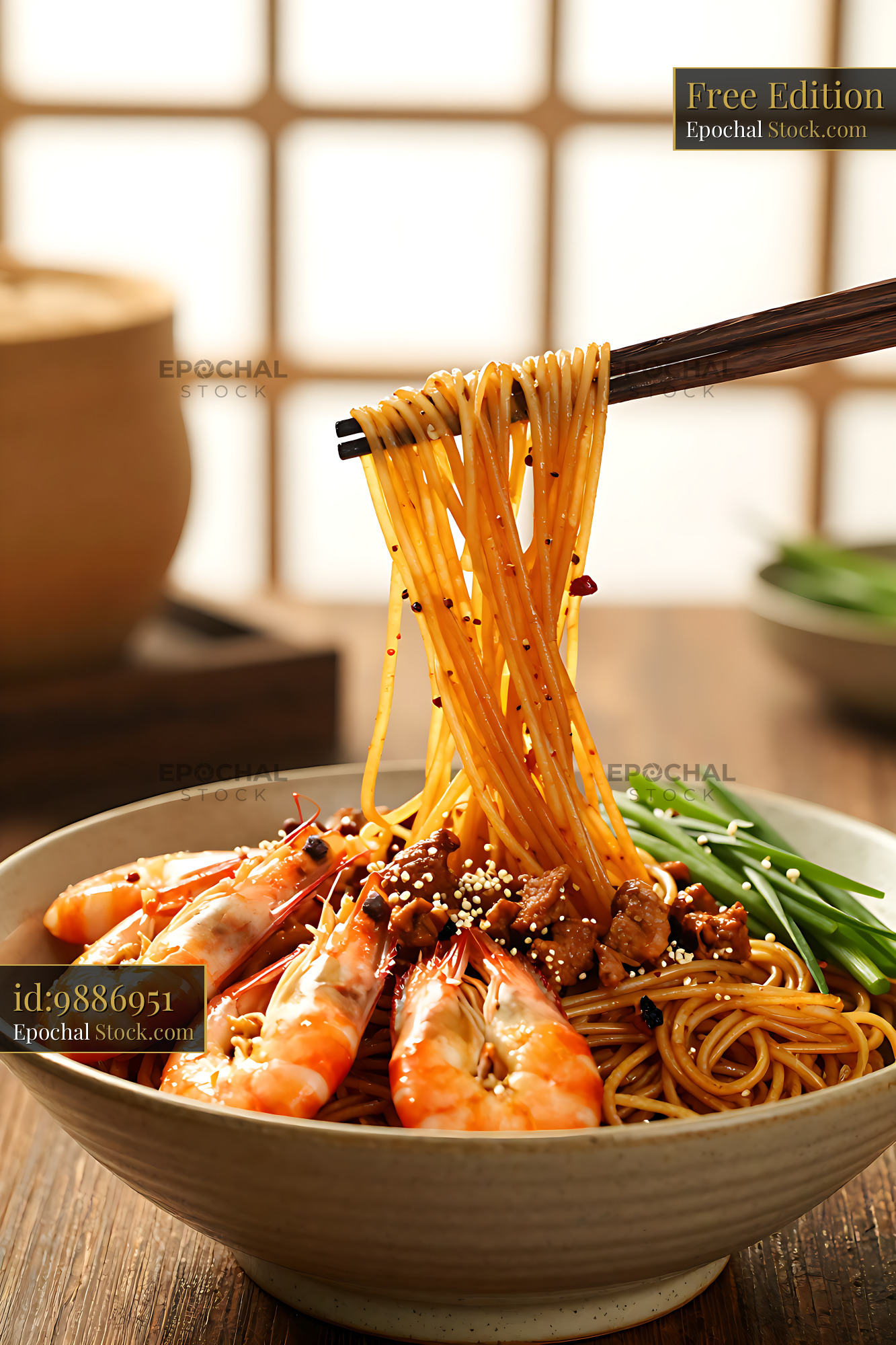 Bowl of savory Hainan Yi Fu Mian noodles with shrimp and chopsticks