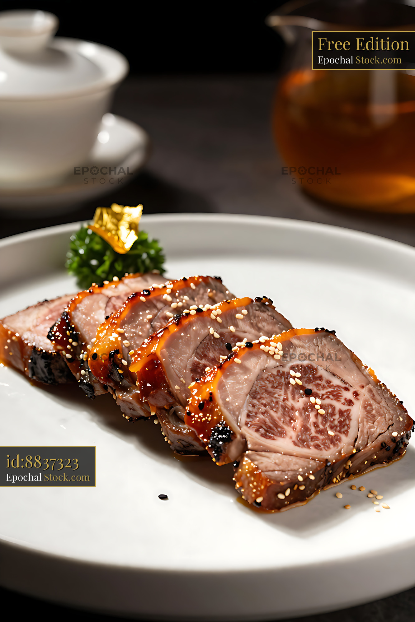 Slices of premium wagyu char siu beef with gold leaf on a white plate - stock photo