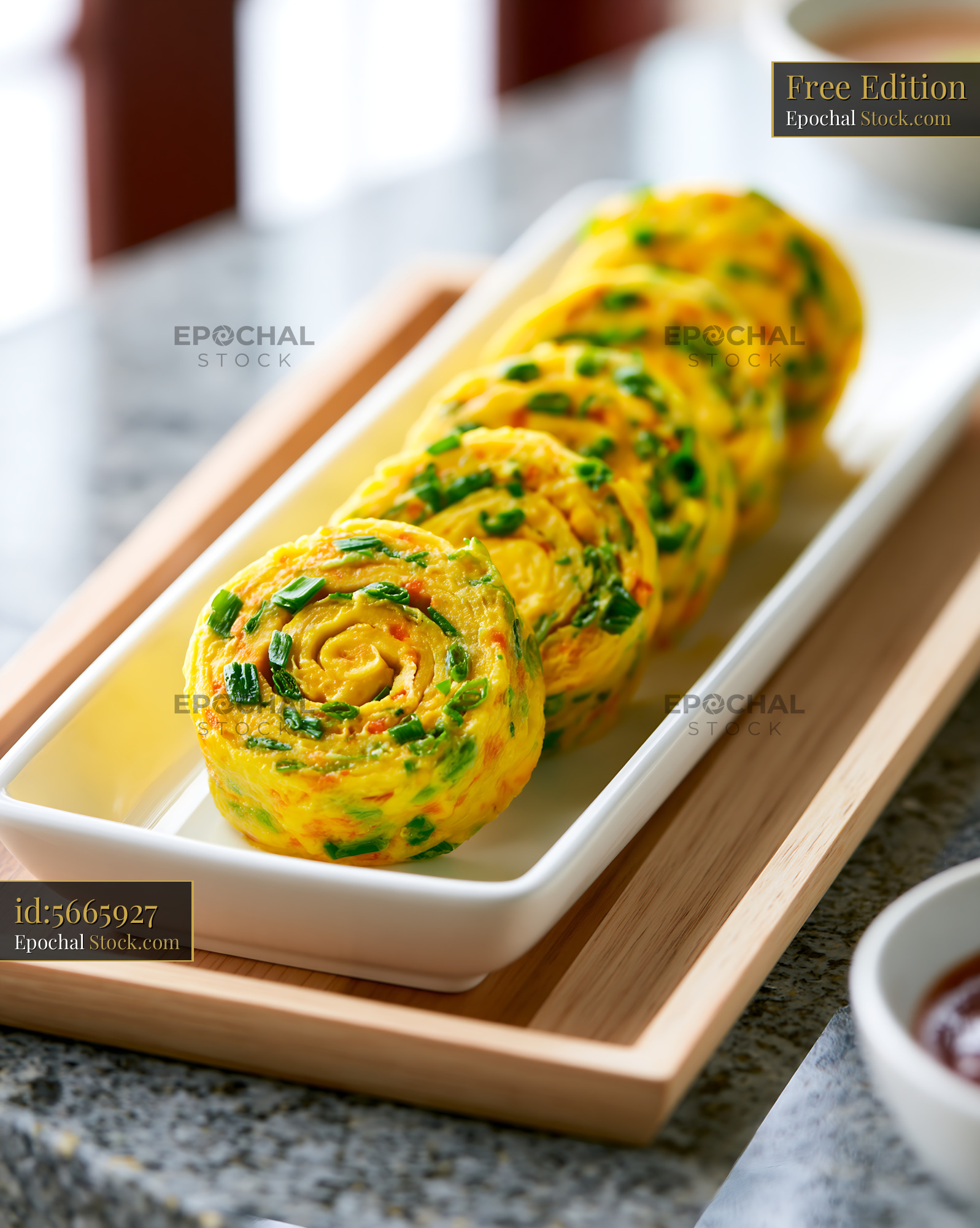 Gyeran-mari Korean rolled omelette with scallions on a white plate - stock photo