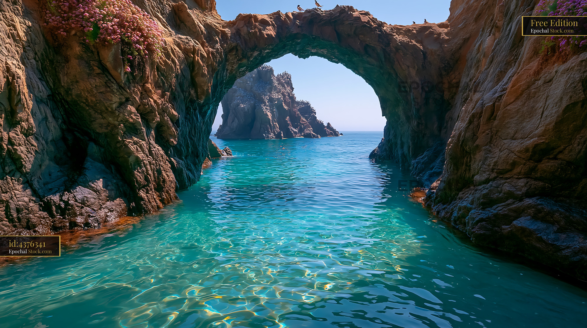 Natural sea arch tunnel over turquoise ocean water on a sunny day - stock photo