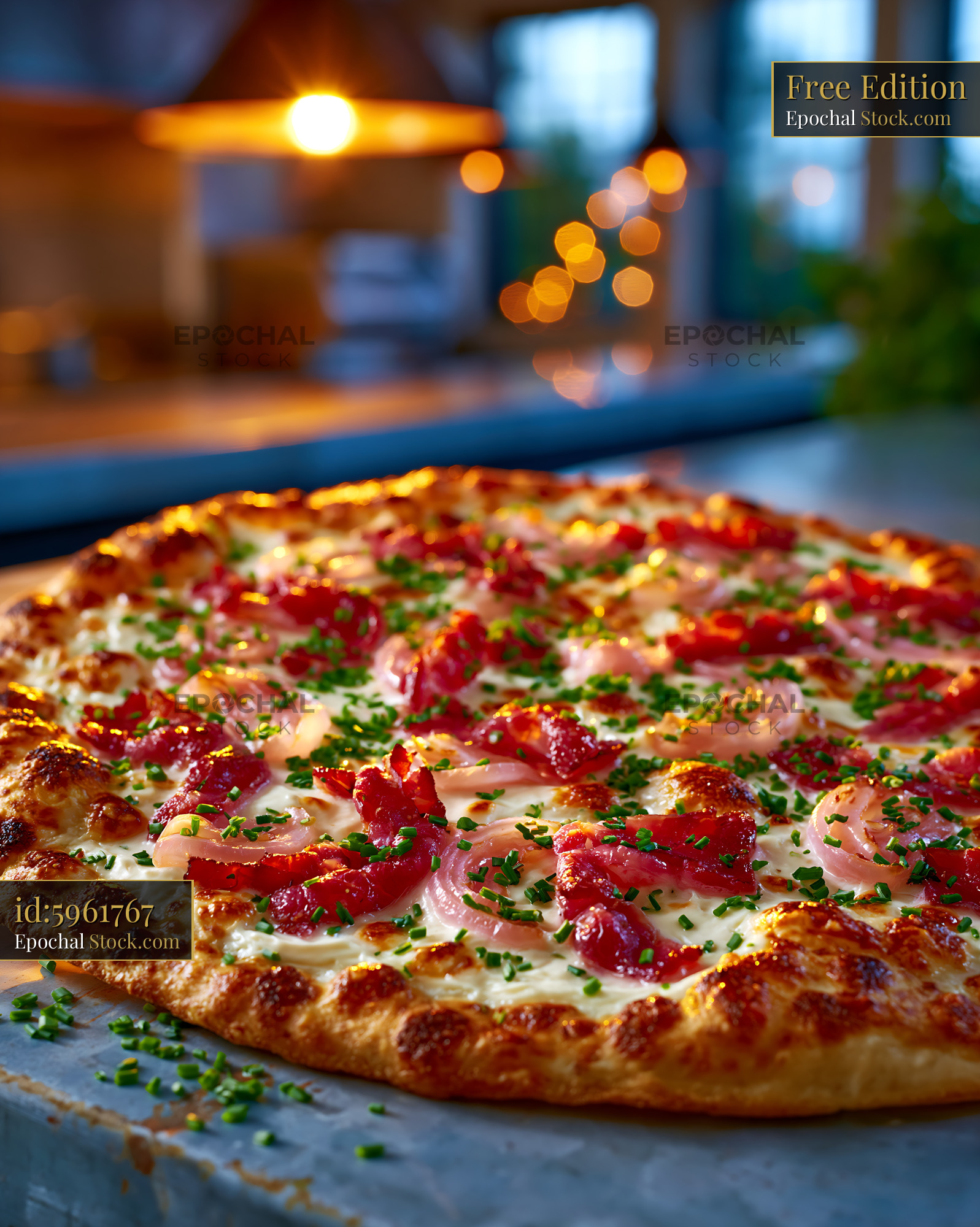 Flammkuchen pizza topped with crispy bacon and onions in warm light - stock photo