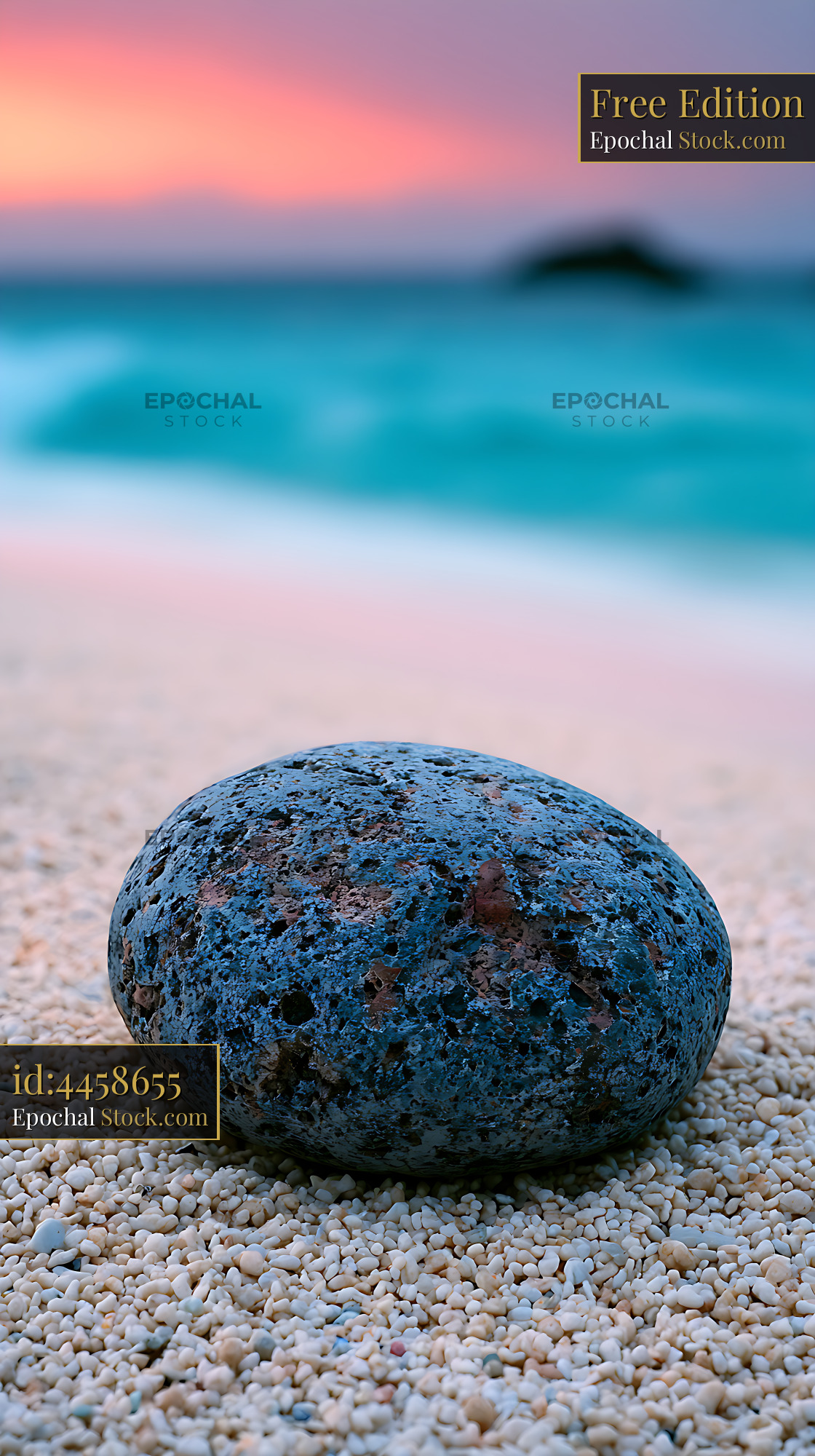 Dark volcanic stone on a pebble beach at Pigeon Island during sunset - stock photo