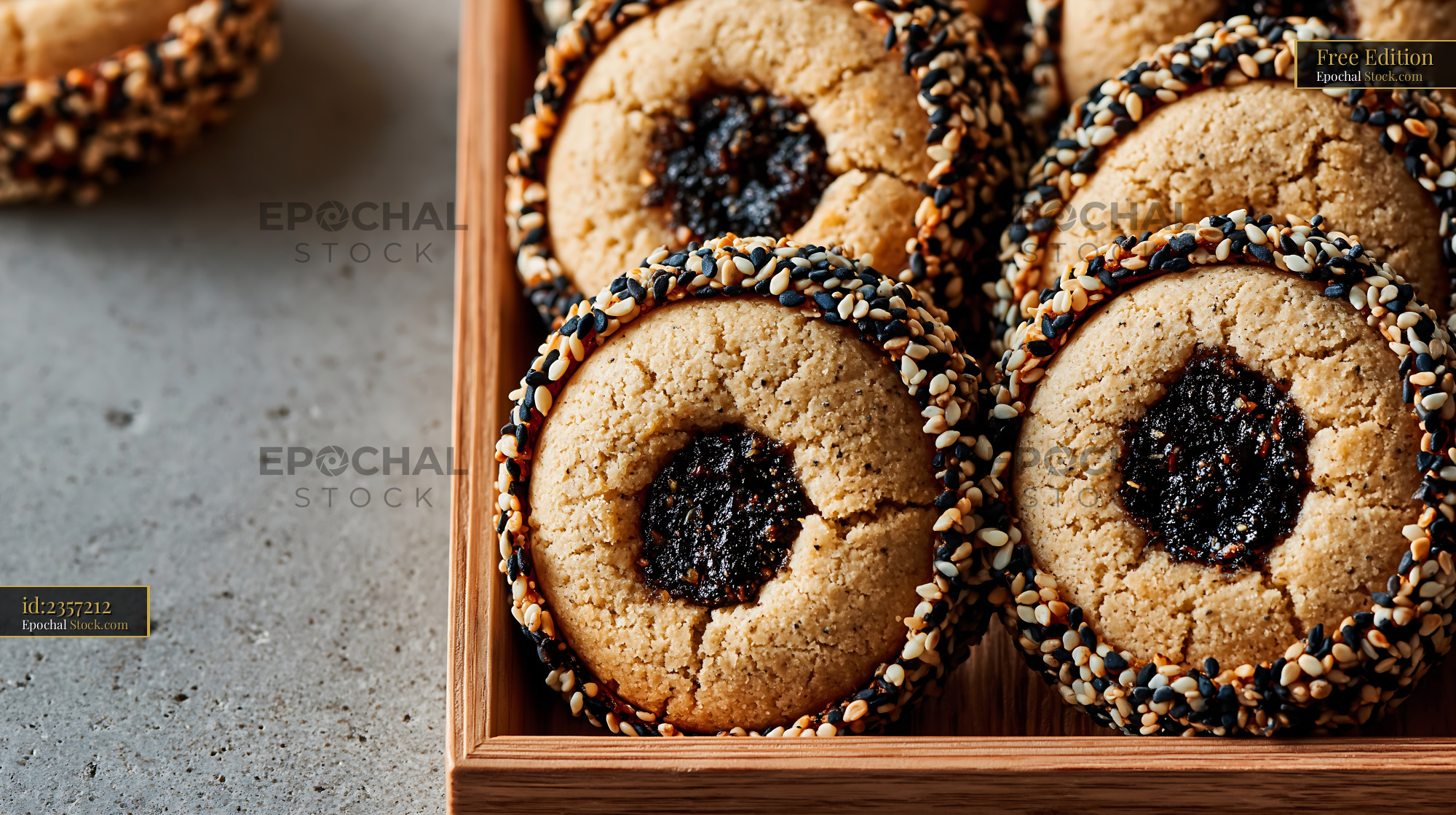 Tahini date biscuits with sesame crust on a rustic wooden tray - stock photo