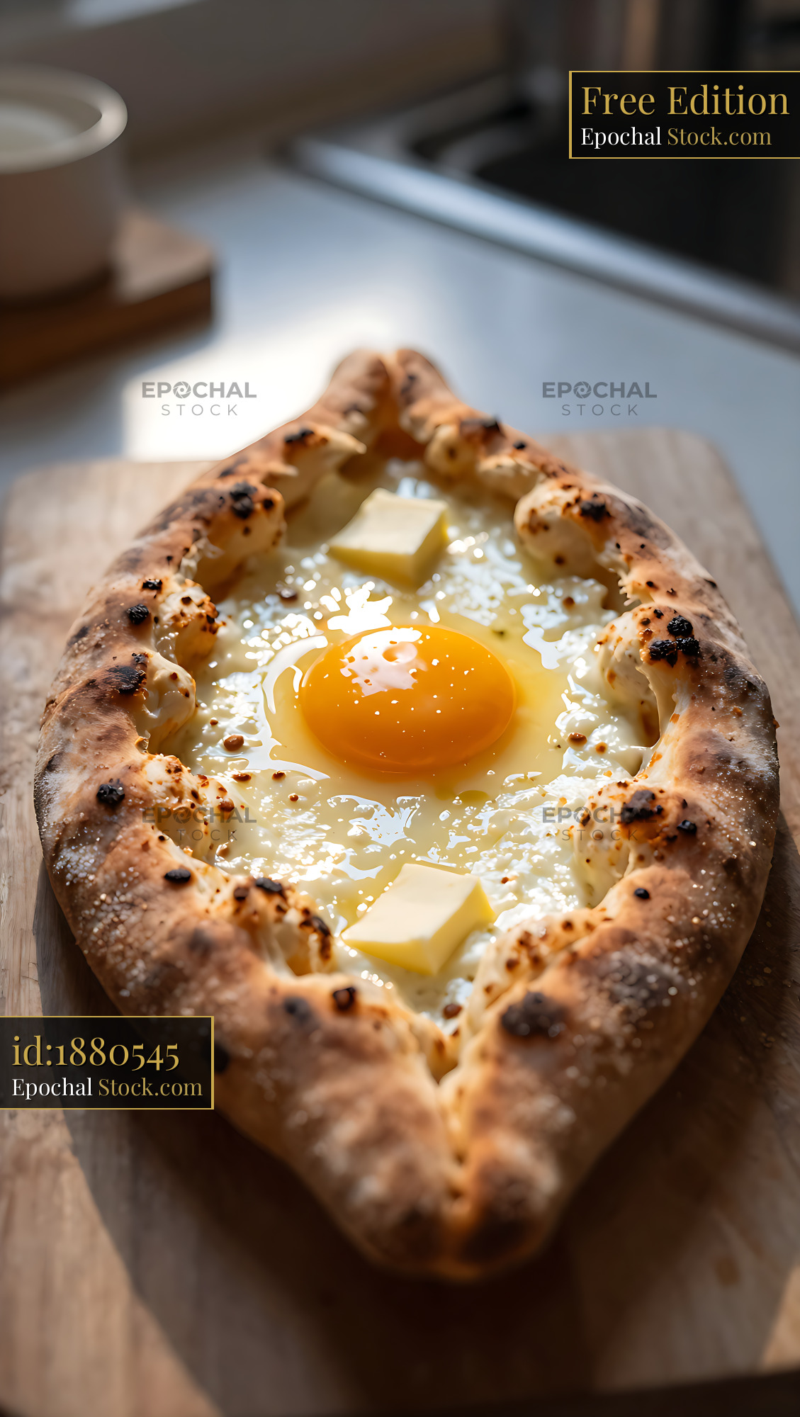 Freshly baked khachapuri adjarian with egg yolk and butter on wood - stock photo