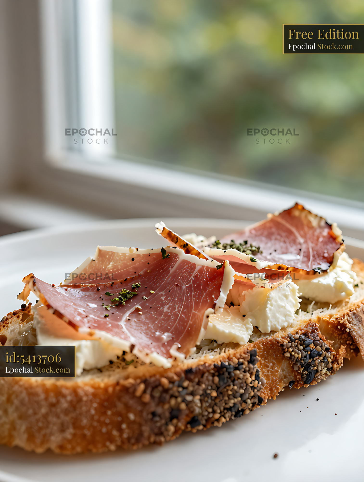 Crostoni di speck e fontina on rustic seeded bread near a window - stock photo
