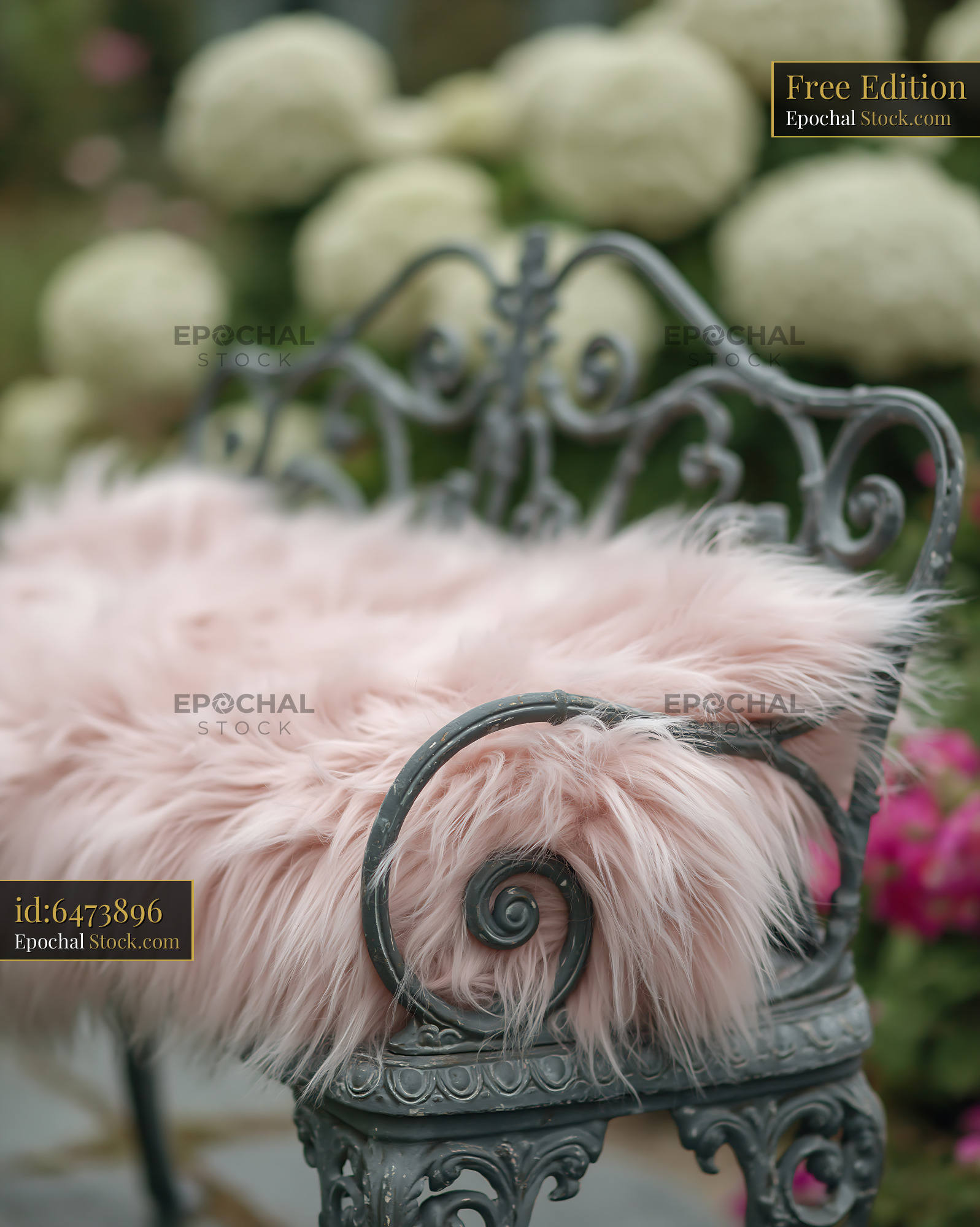 Shabby chic bench with pink blanket in a blooming hydrangea garden - stock photo