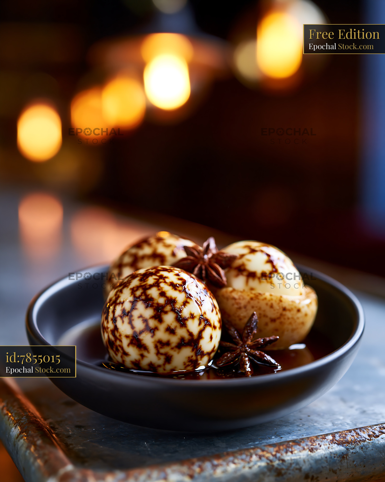 Chinese marbled tea eggs in a dark bowl with star anise - stock photo