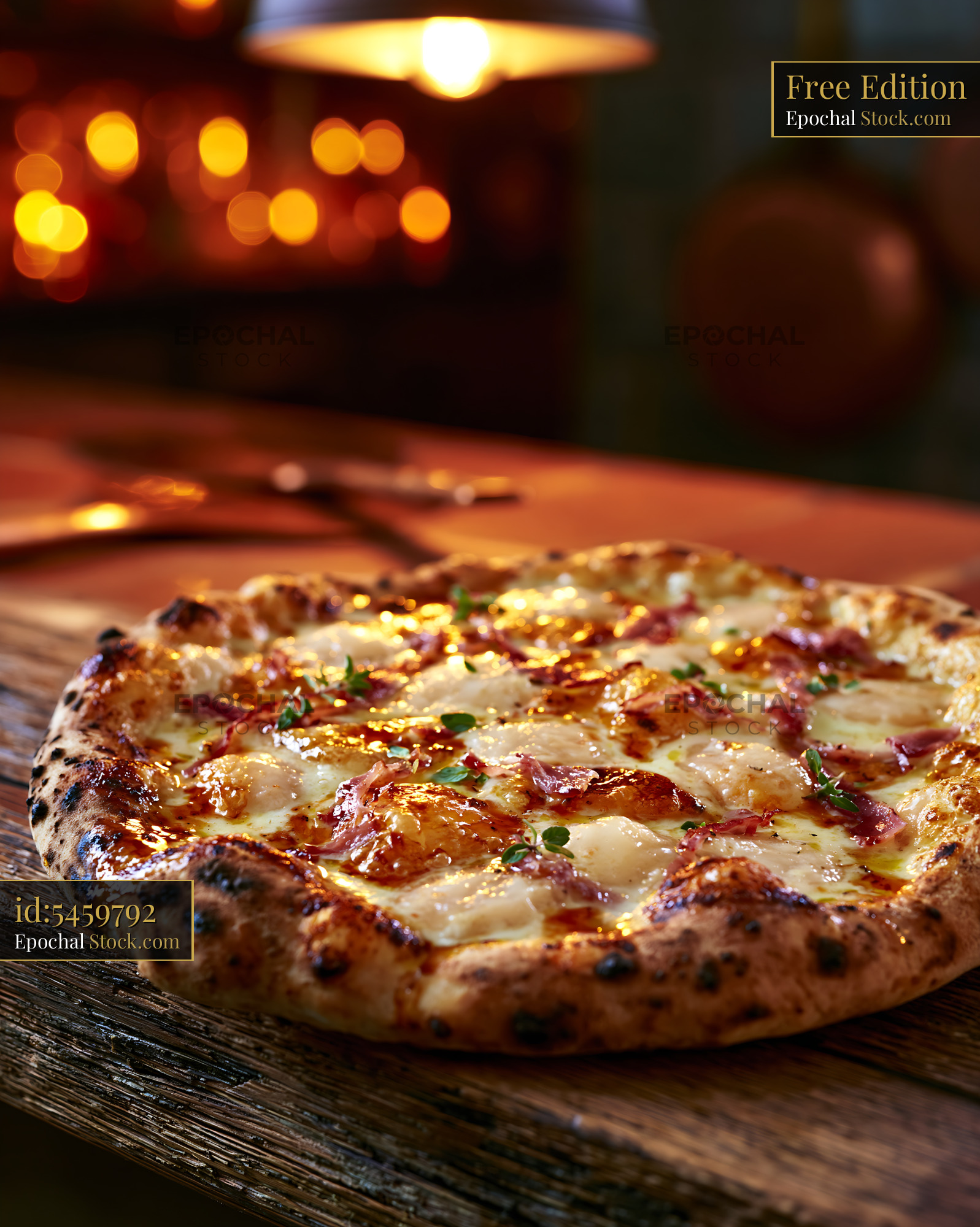 Artisan scamorza affumicata pizza with ham on a rustic wooden board - stock photo
