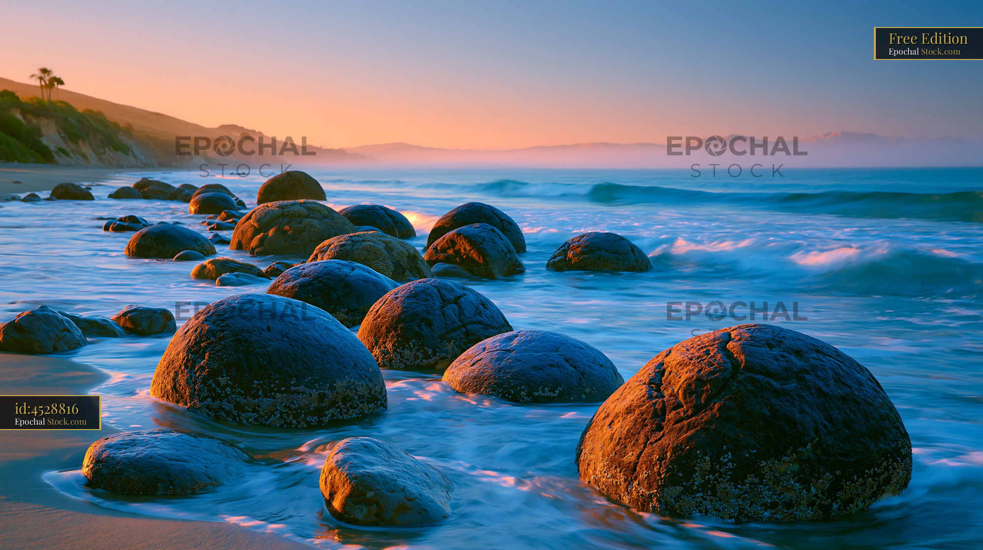 Moeraki Boulders on Koekohe Beach at sunrise with golden light - stock photo