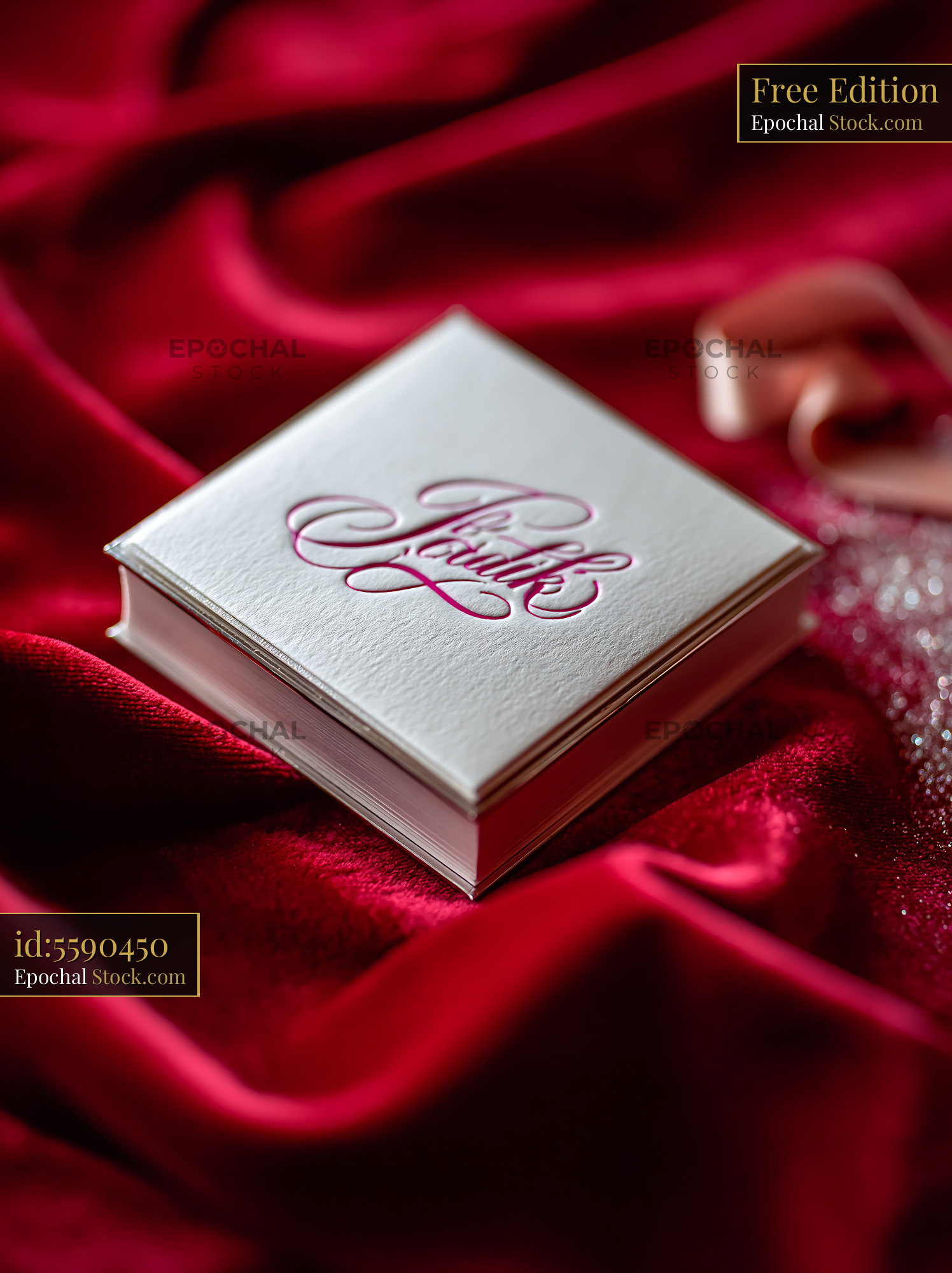 Elegant white invitation card on red velvet with pink calligraphy - stock photo