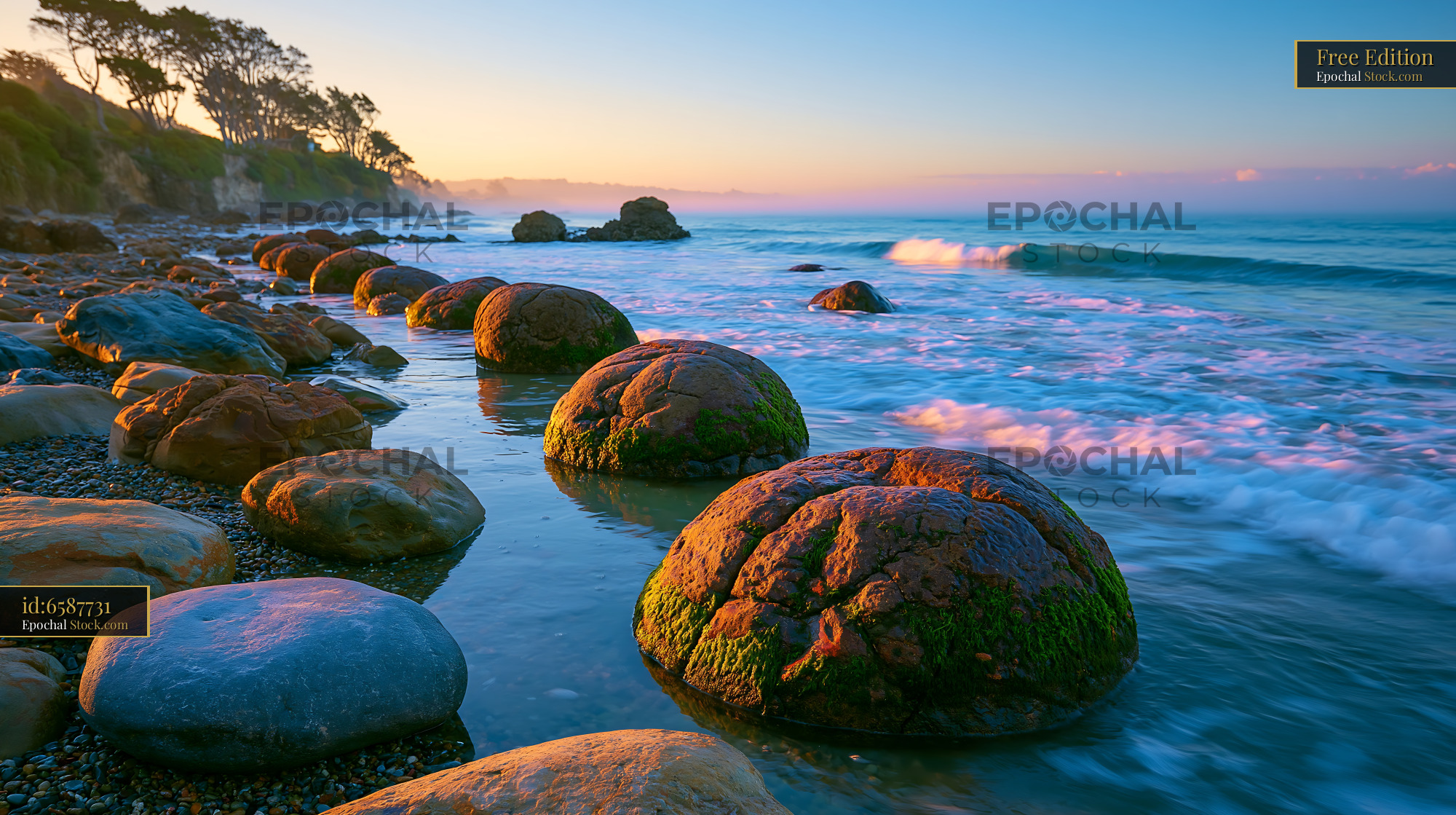 Moeraki Boulders on the shore during a colorful sunrise - stock photo