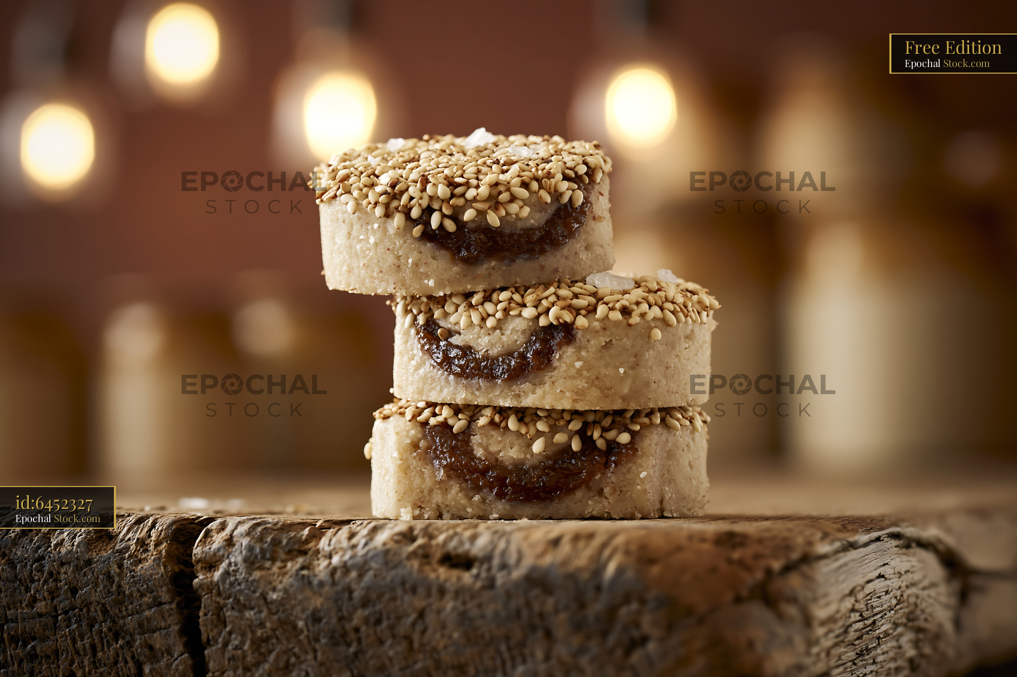 Tahini date biscuits with sesame seeds on rustic wooden board - stock photo