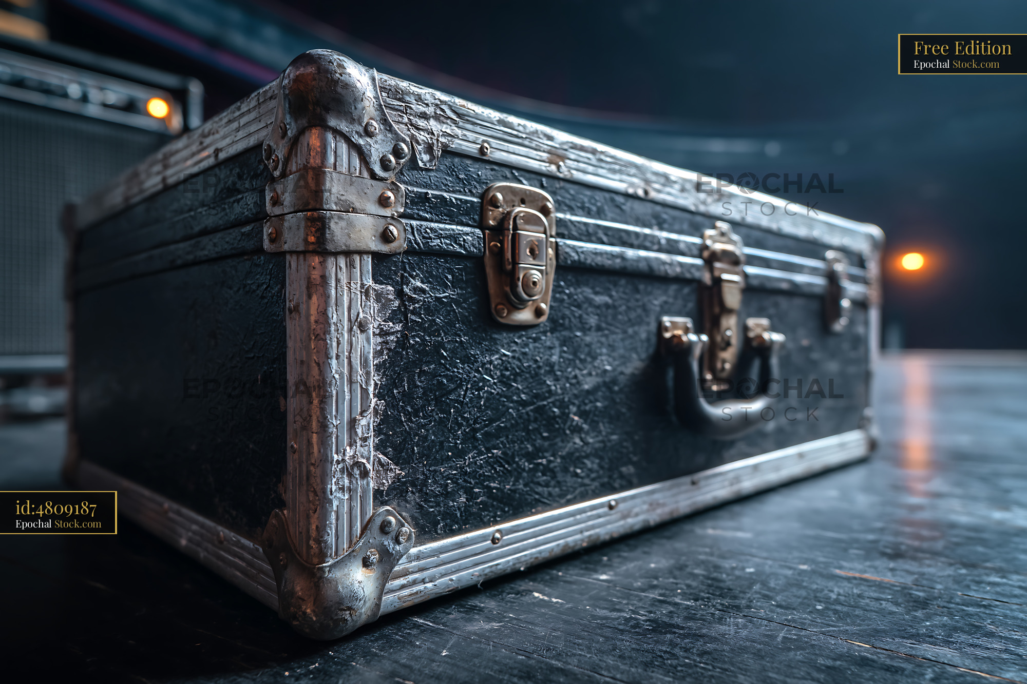 Worn black road case on an empty stage with concert lights - stock photo