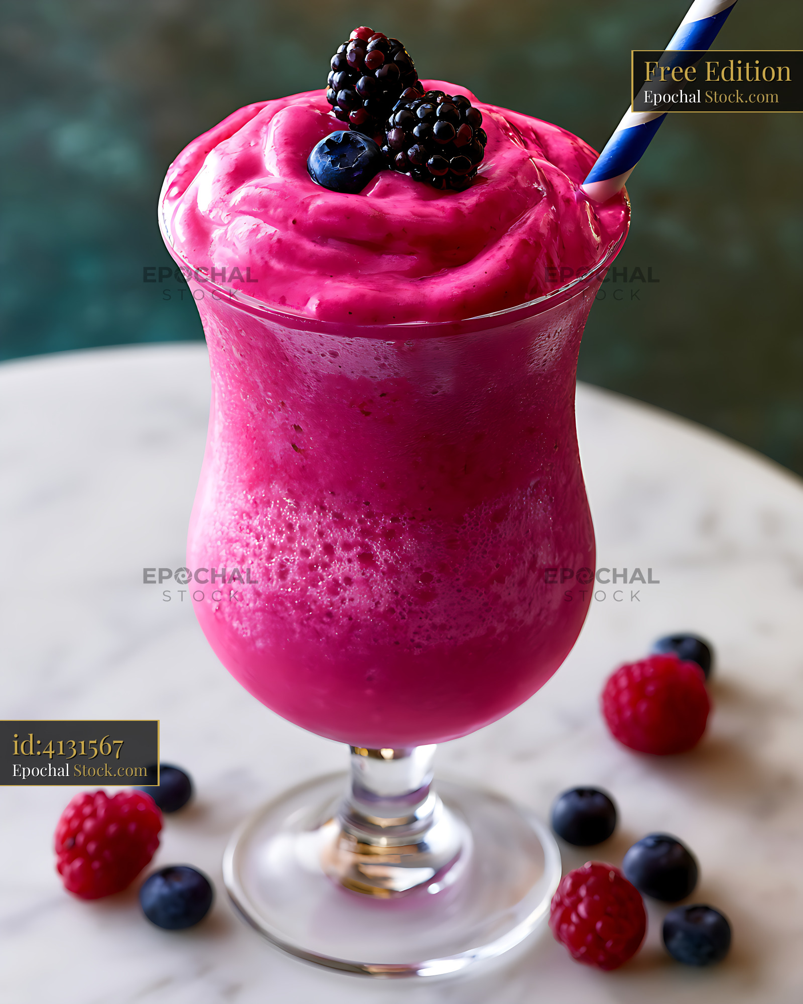 Vibrant elderberry milkshake topped with fresh blackberries and straw - stock photo