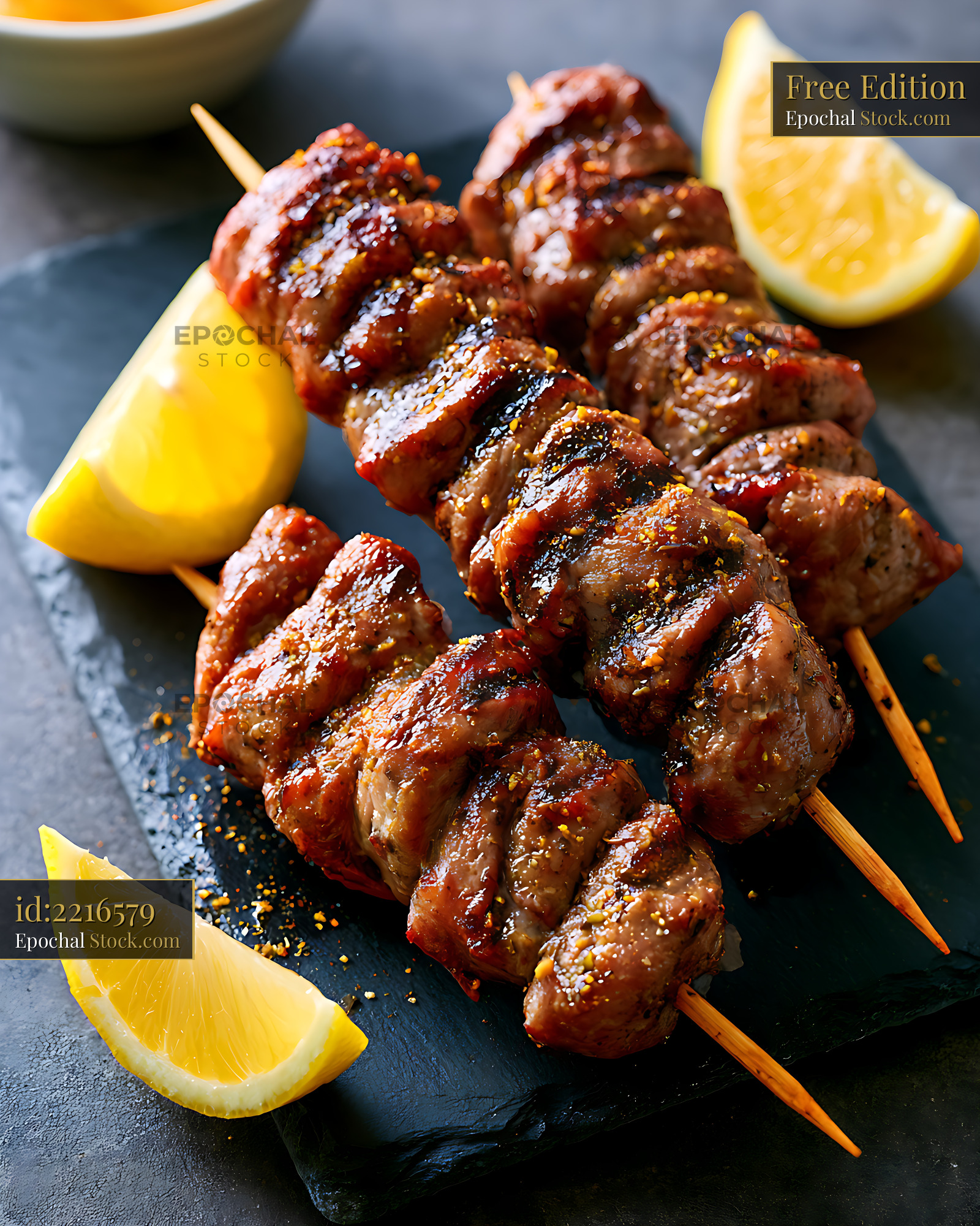 Grilled stigghiola palermitana skewers with fresh lemon slices - stock photo